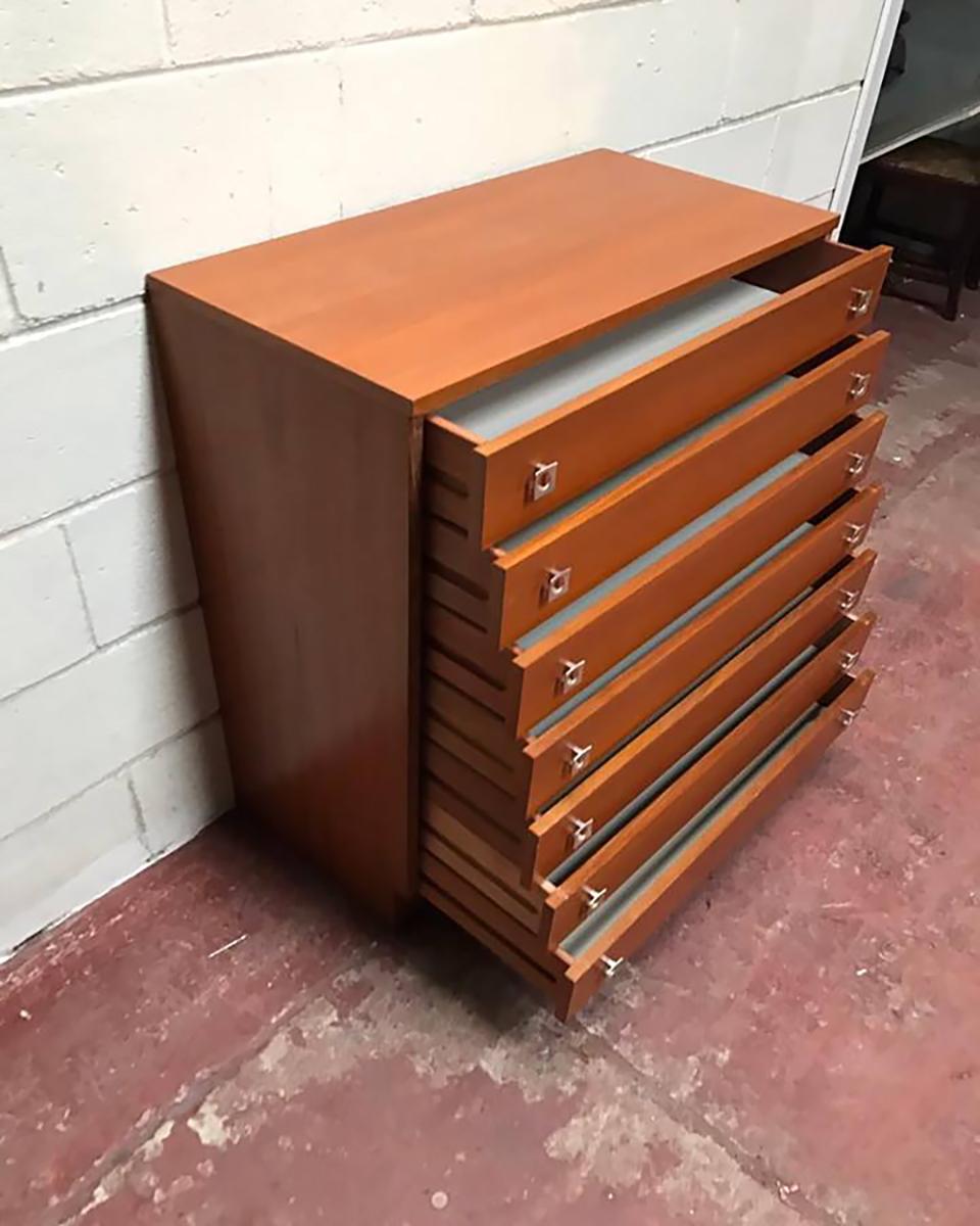 Chest of drawers from 1950s-1960s. Surface veneered with teak, chest has seven capacious drawers. Very in good condition.