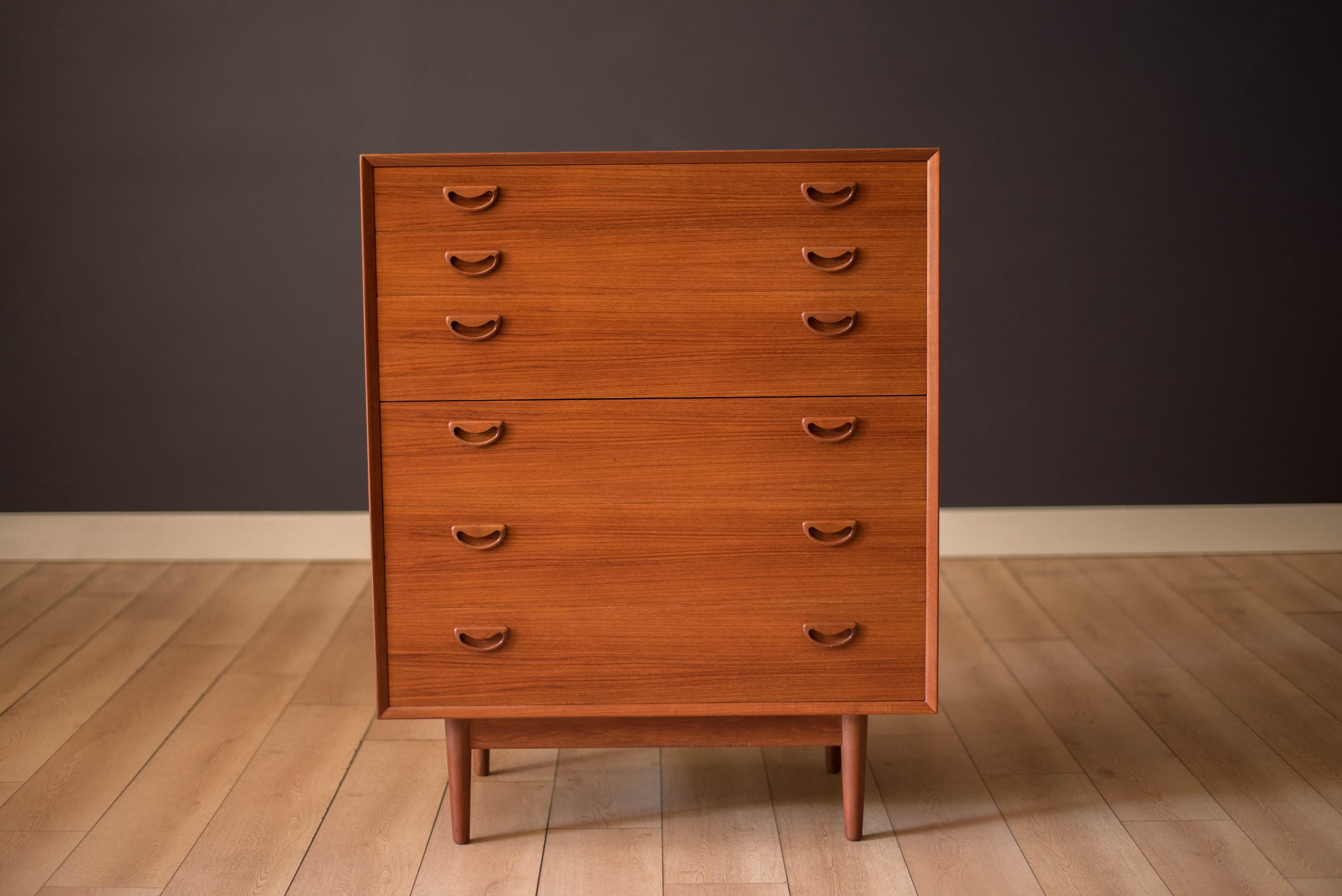 Mid century modern highboy dresser in teak circa 1960's. Features solid wood sculptural handles and natural bookmatched grains. Offers plenty of storage space equipped with six drawers. Matching double lowboy dresser available in separate listing. 