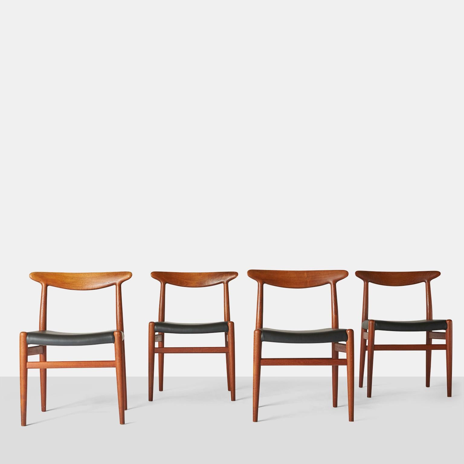 A set of four teak W2 dining chairs by Hans J. Wegner. Made for CM Madsen factory. Sometimes referred to as 