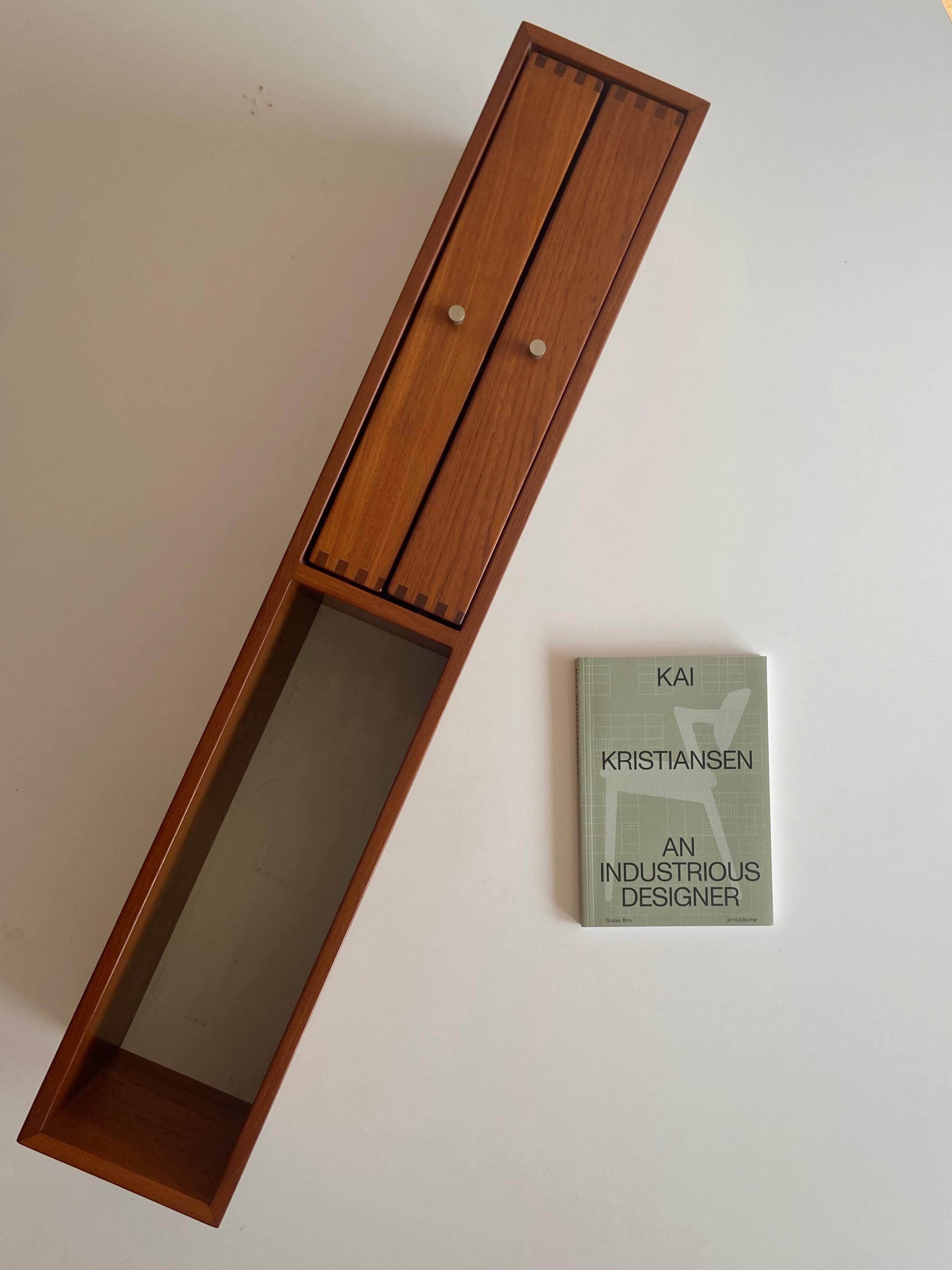 1960s Teak wall board / teak wood hanging shelf no. 132 designed by Kai Kristiansen and signed/produced by cabinetmaker Aksel Kjaersgaard, Odder Made in Denmark.
With two drawers.

  
 