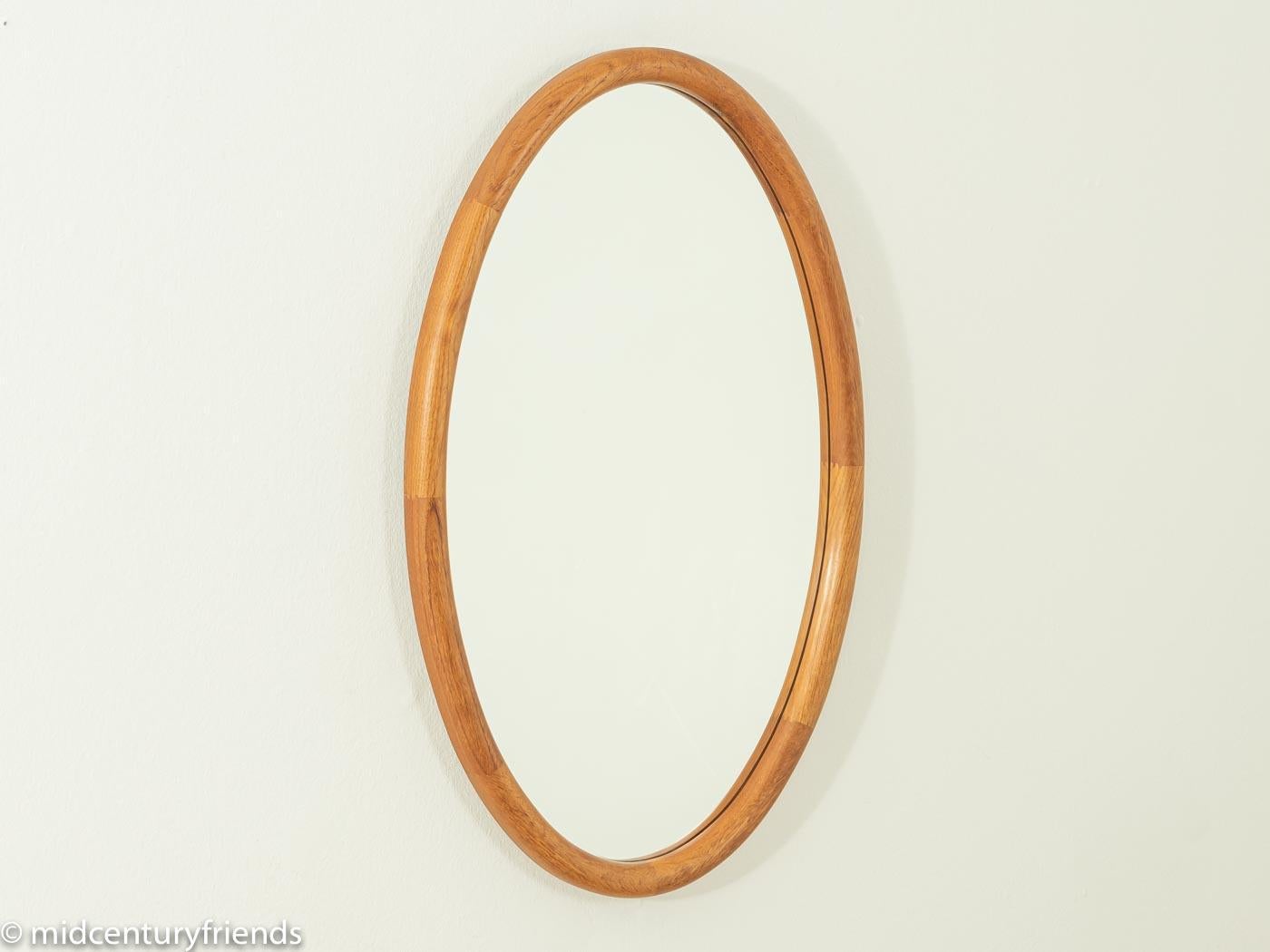 Wonderful mirror from the 1960s with a high-quality solid teak frame.