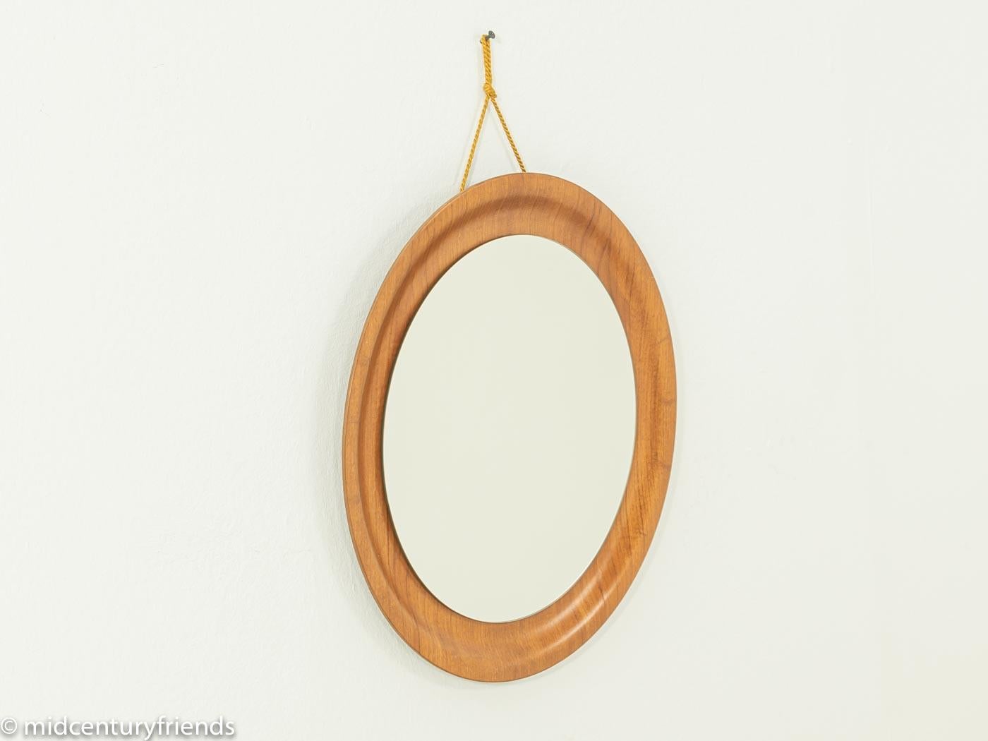 Classic mirror from the 1960s with a teak frame. Made in Germany.