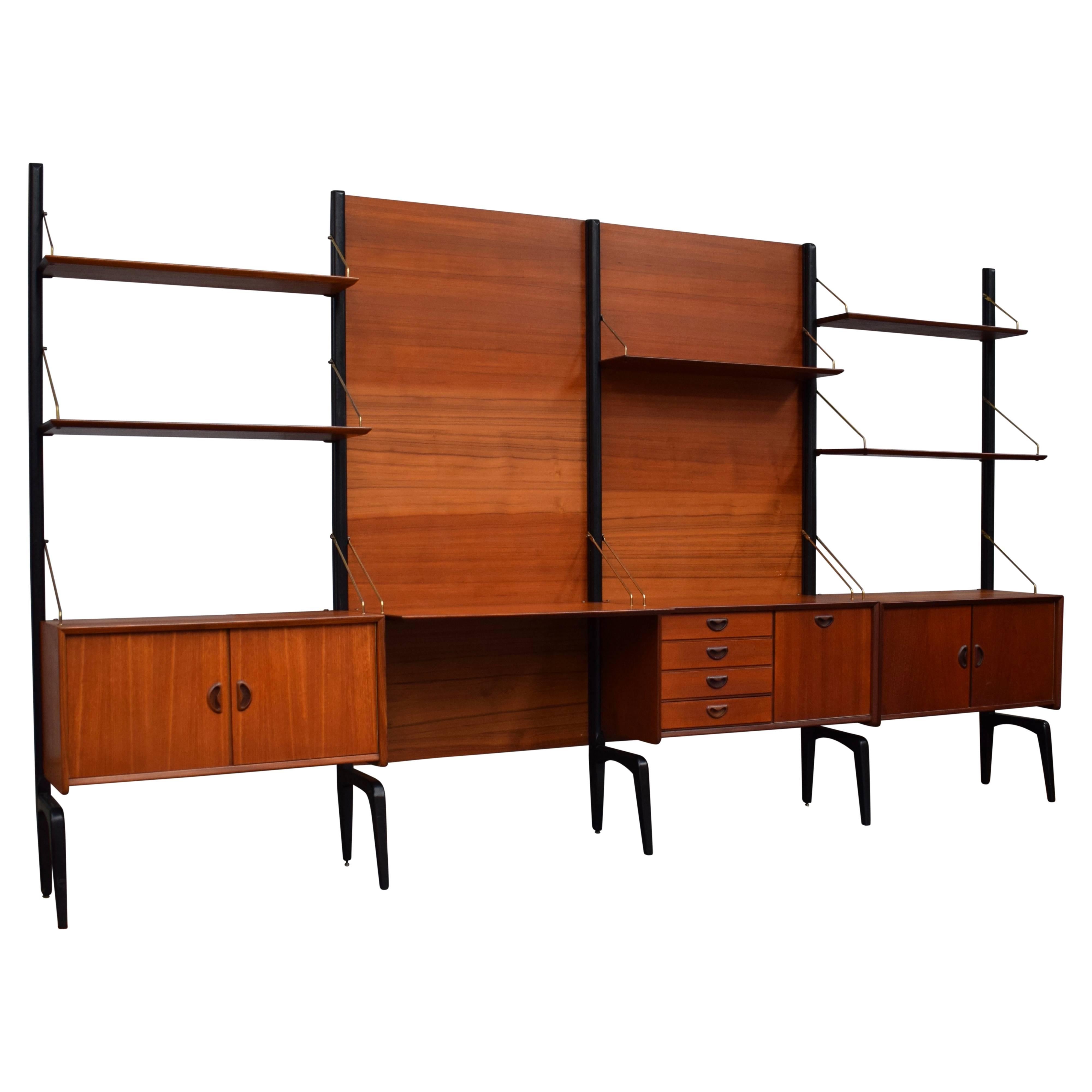 Freestanding modular wall-unit by Louis van Teeffelen for WéBé, 1960s. The back panels are rare to find. The unit is made of a combination of solid and veneer teak with brass details.

Designer: Louis Van Teeffelen

Manufacturer: WéBé, Walraven