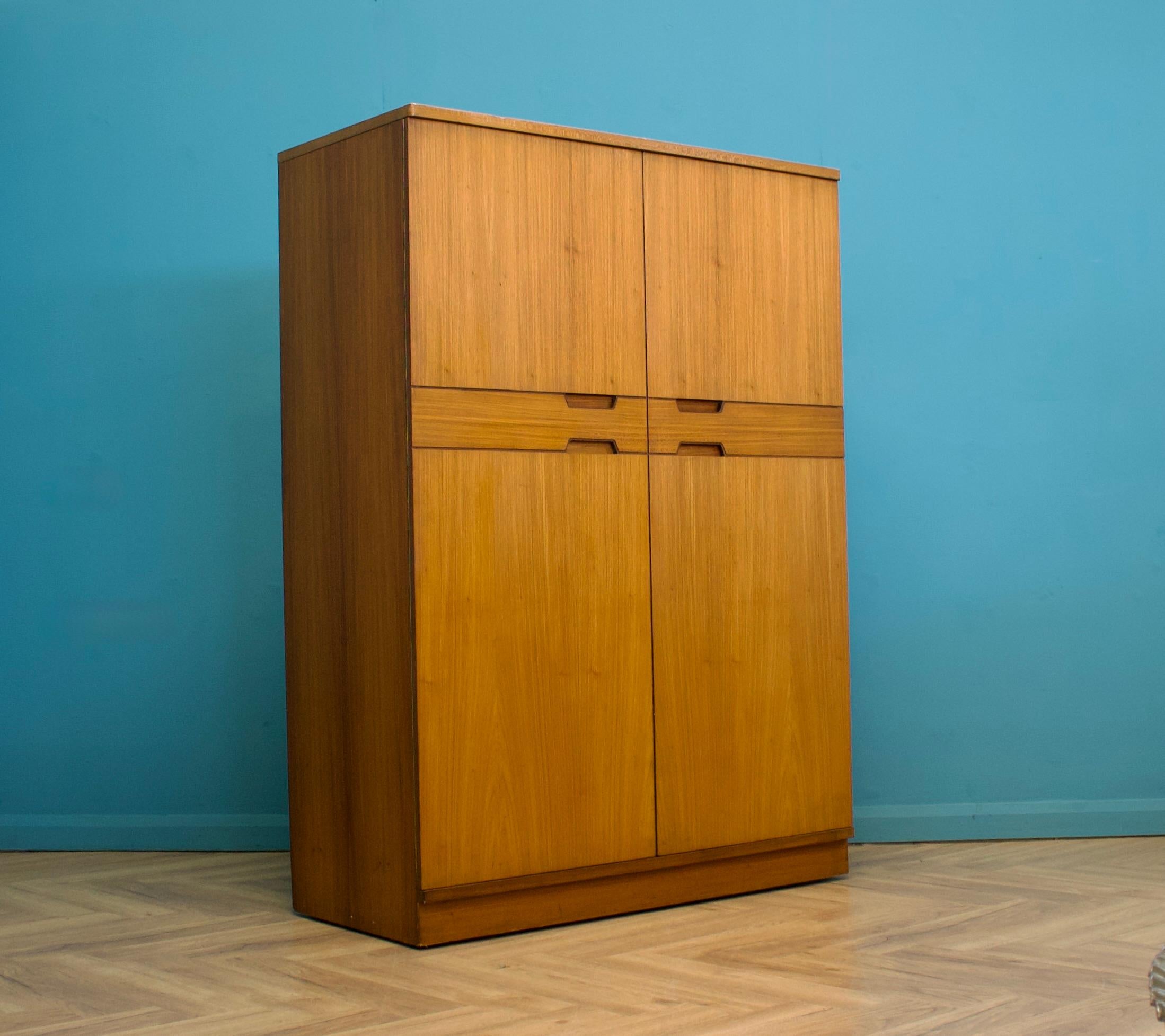A freestanding double door teak wardrobe from Uniflex - designed by Gunther Hoffstead
Made during the 1960s

Fitted out with a clothes rail the full width
The style of this wardrobe is quite minimalist - with it's clean lines

This wardrobe can be