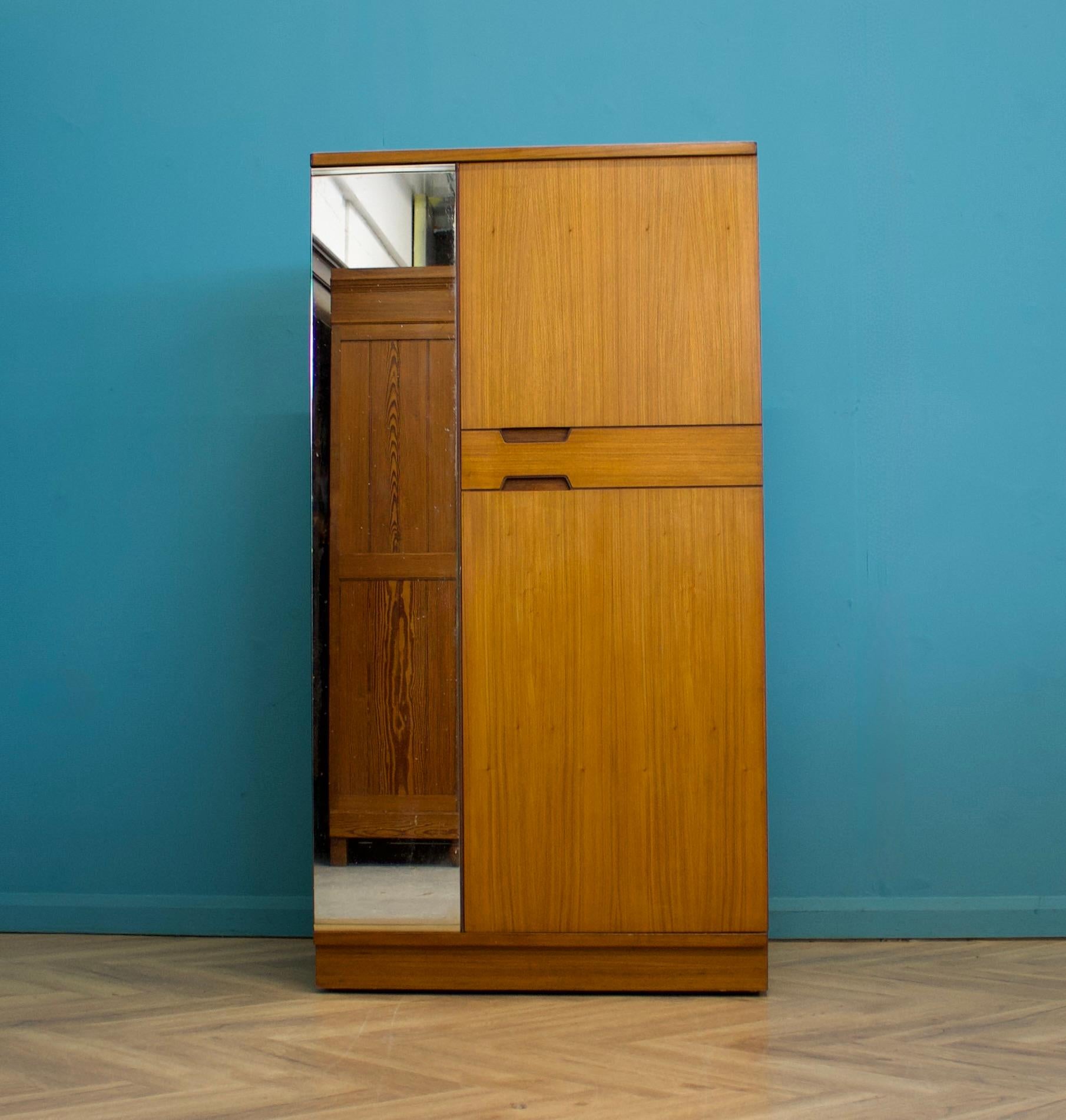 A freestanding double door teak wardrobe from Uniflex - designed by Gunther Hoffstead
Made during the 1960s
 
Fitted out with a clothes rail, drawers and shelves
The style of this wardrobe is quite minimalist - with it's clean lines 
 
This wardrobe