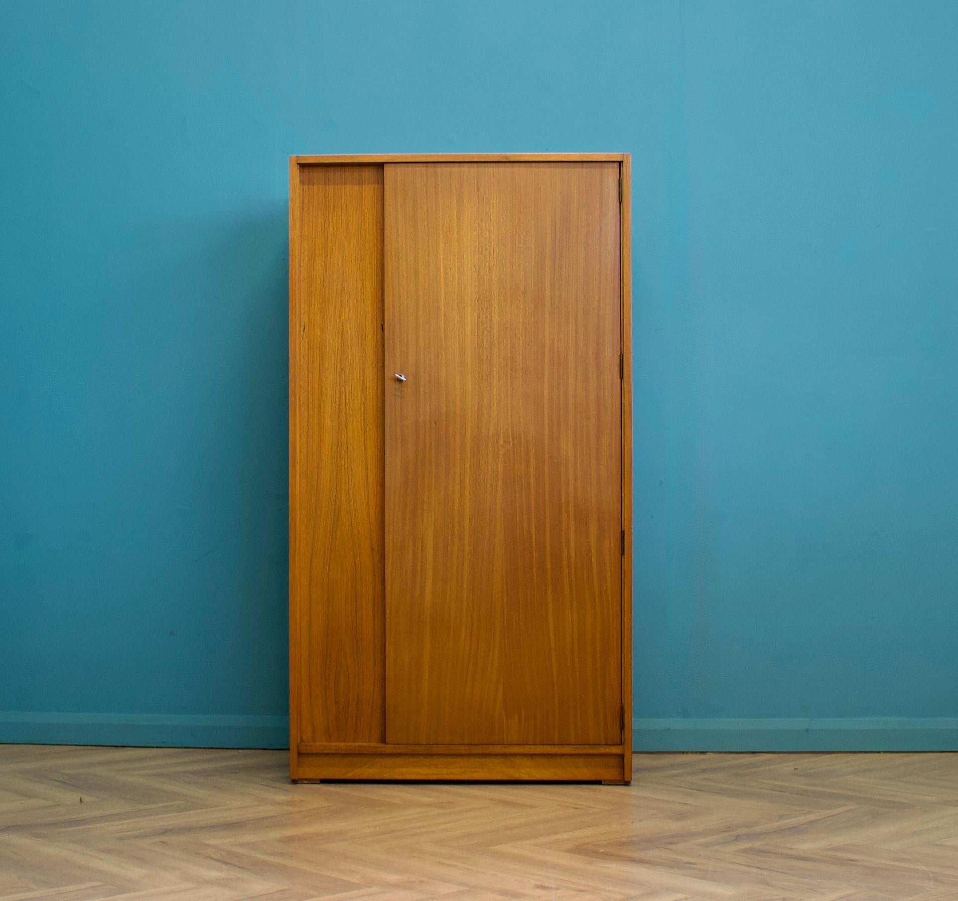 A freestanding teak wardrobe from Uniflex - designed by Gunther Hoffstead
Made during the 1950s
 
Fitted out with a clothes rail and shelves
The style of this wardrobe is quite minimalist - with it's clean lines 
 
This wardrobe can be dismantled

