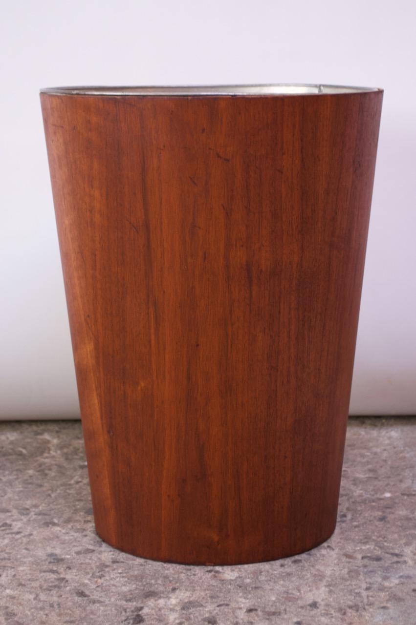 Wastebasket by Martin Åberg for Servex / House of Rainbow Wood Products, Sweden, circa mid-1950s. Conical, teak vessel houses the original aluminum liner. Refinished condition, but wear consistent with age and use remains (nicks / scuffs to