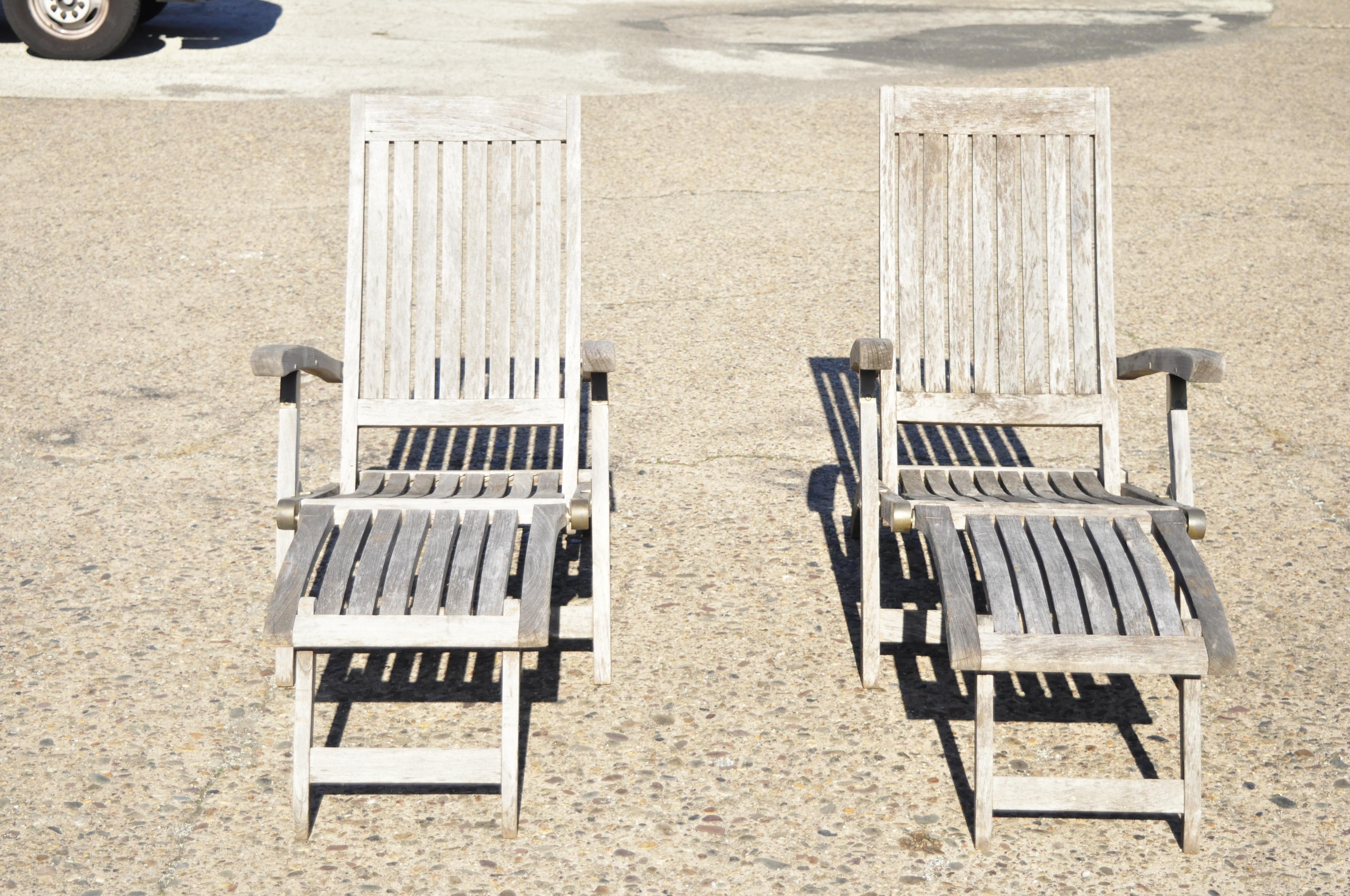 Teak Wood & Brass Folding Steamer Deck Lounge Pool Chair Chaise Lounge - a Pair. Item features burnished brass hardware, folding frames, fold out footrest, solid wood construction, original brass label, great style and form. Circa Late 20th Century.