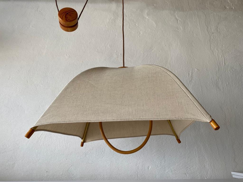 Teak Wood & Fabric Shade Counterweight Pendant Lamp by Domus, 1980s Italy

Minimalist and rare design. 

Lampshade is in good condition and clean. 
This lamp works with E27 light bulb. 
Max 100W Wired and suitable to use with 220V and 110V for