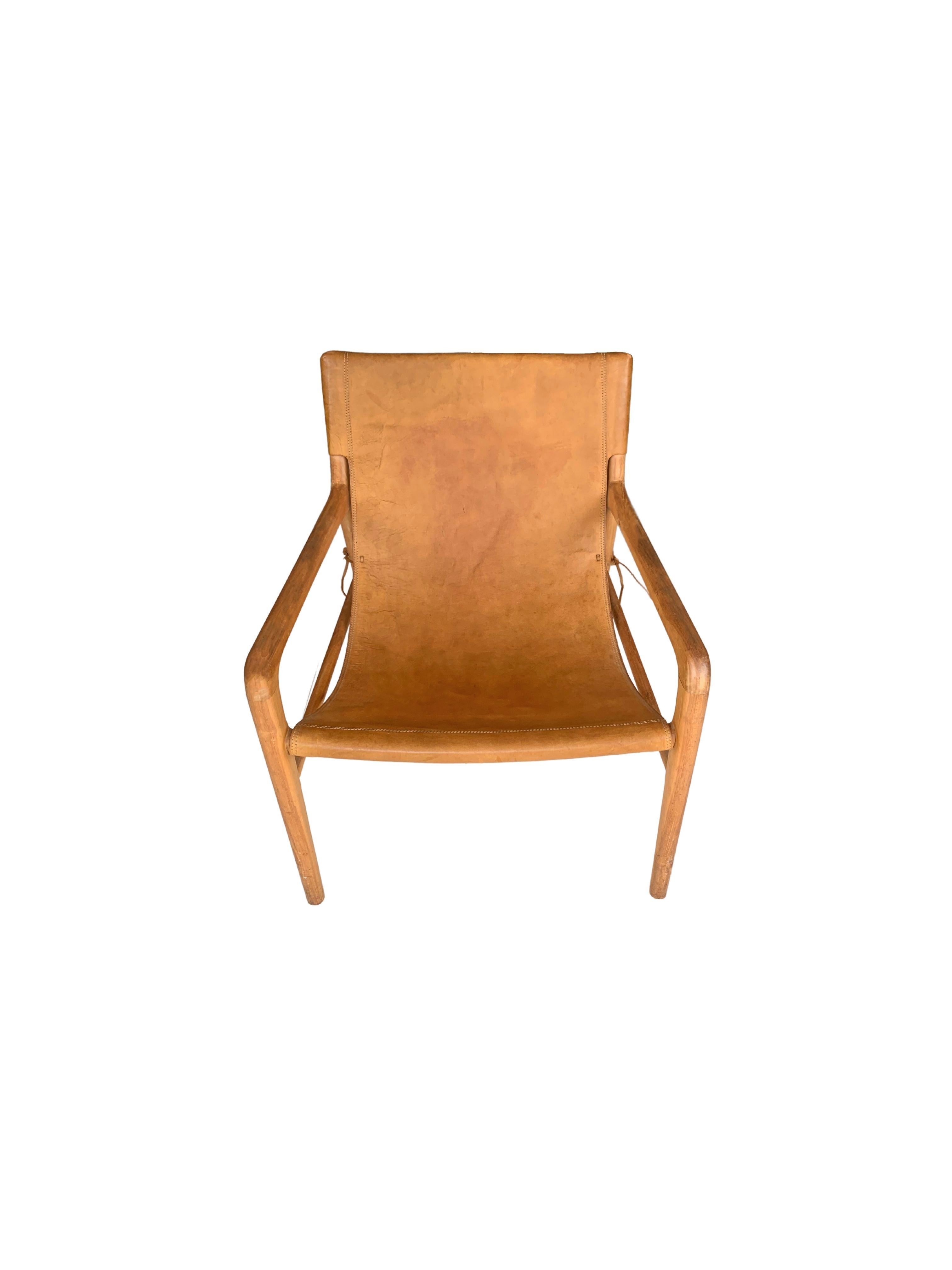A hand-crafted teak framed & hanging leather seat lounger chair. These chairs are crafted by local artisans using a wood joinery technique without the use of nails. They feature a subtle wood texture and are robust and sturdy.