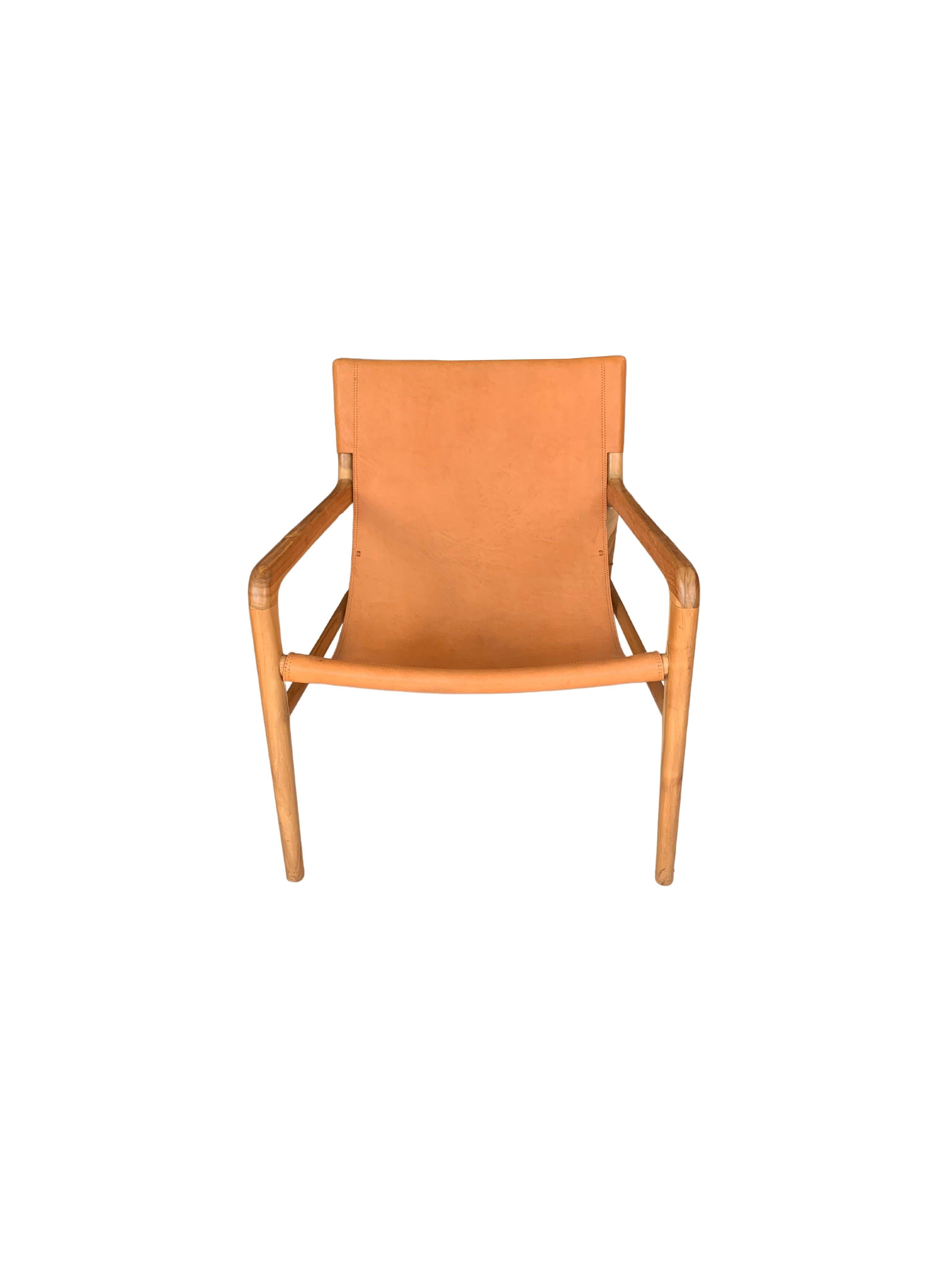 A hand-crafted teak framed & hanging leather seat lounger chair. These chairs are crafted by local artisans using a wood joinery technique without the use of nails. They feature a subtle wood texture and are robust and sturdy.