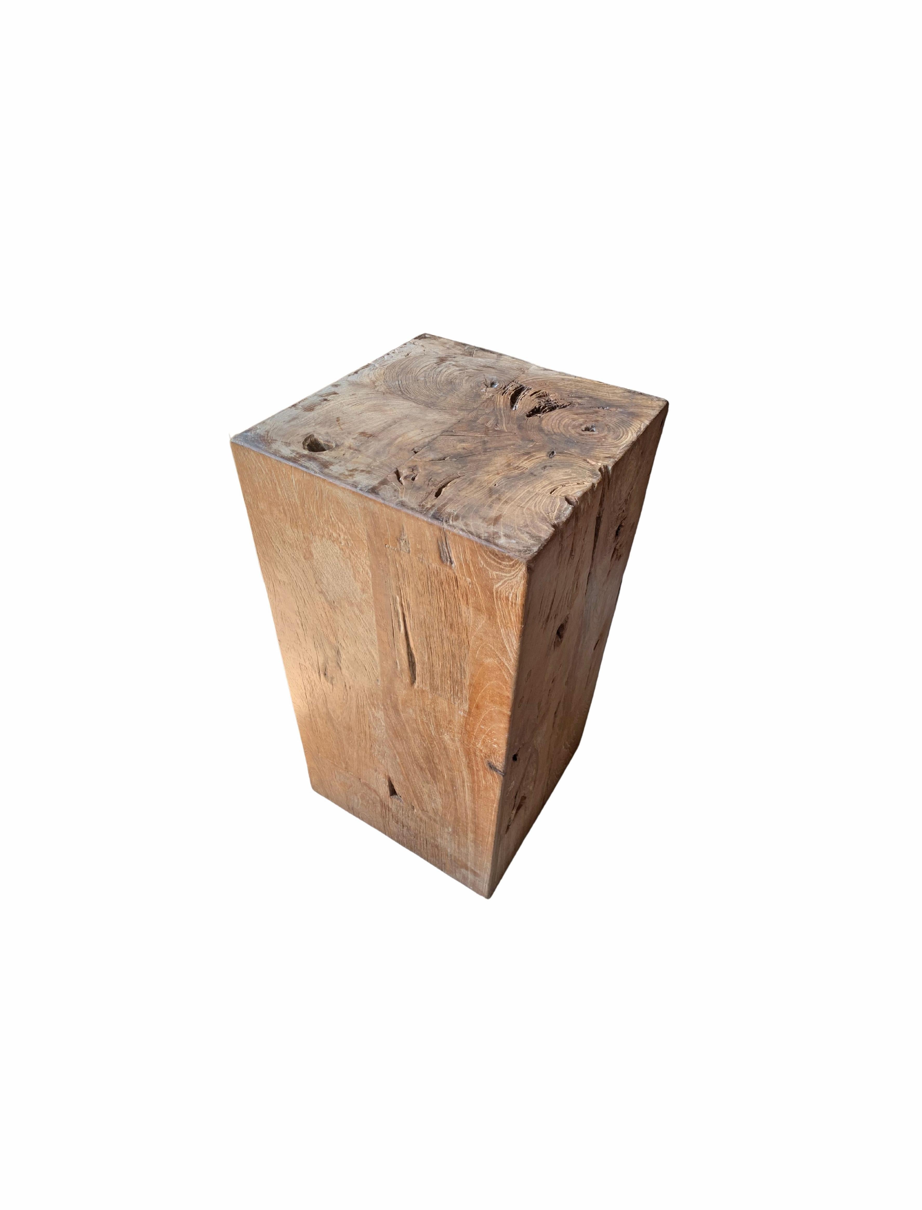 This teak wood pedestal was crafted by moulding 4 blocks of solid teak wood together. A strong and robust pedestal that is both beautiful on its own or displaying sculptures, vases or other items. A wonderfully organic item to brighten up any space.