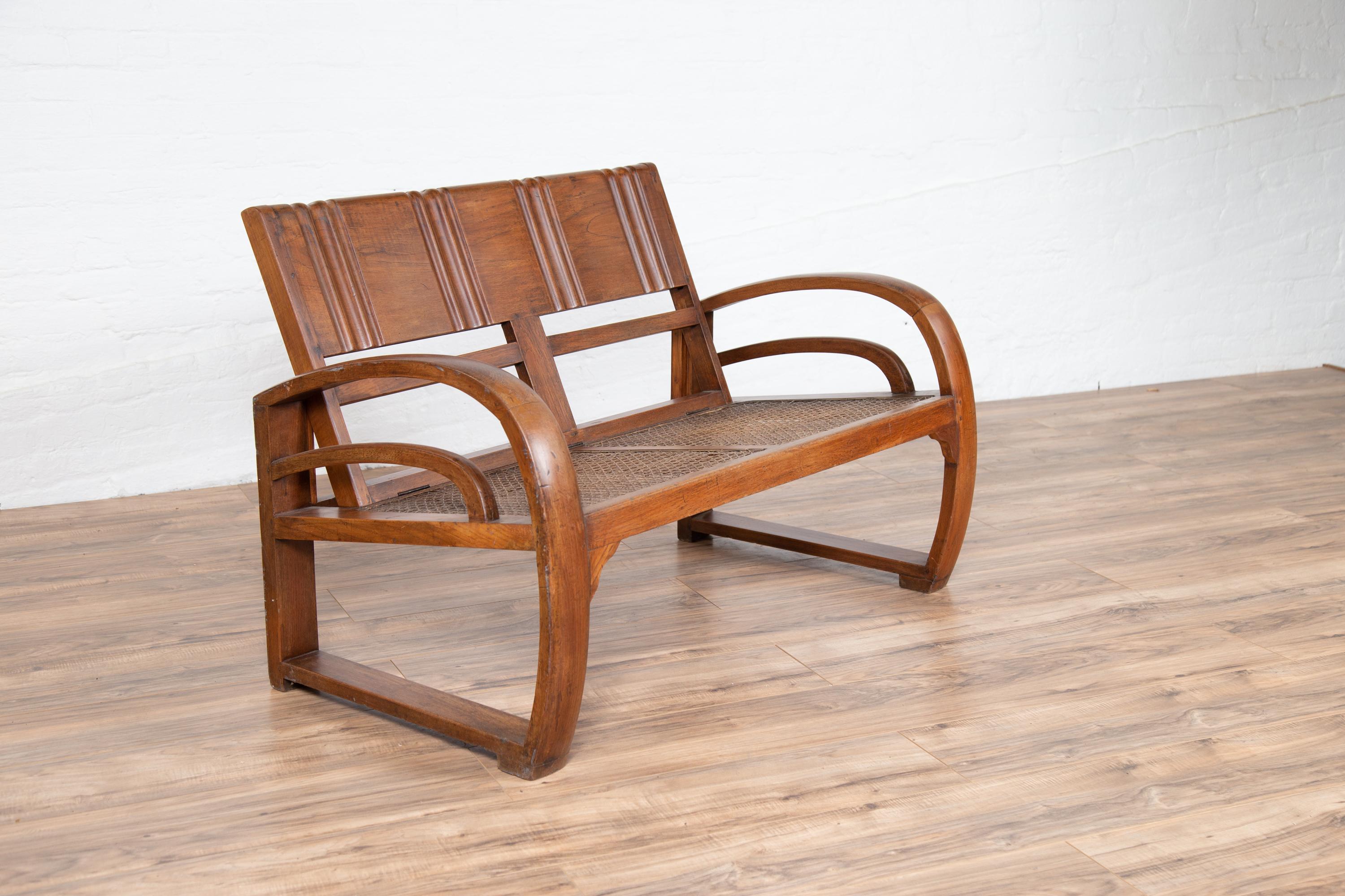 Teak Wood Settee from Madura with Folding Back, Looping Arms and Cane Seat For Sale 4