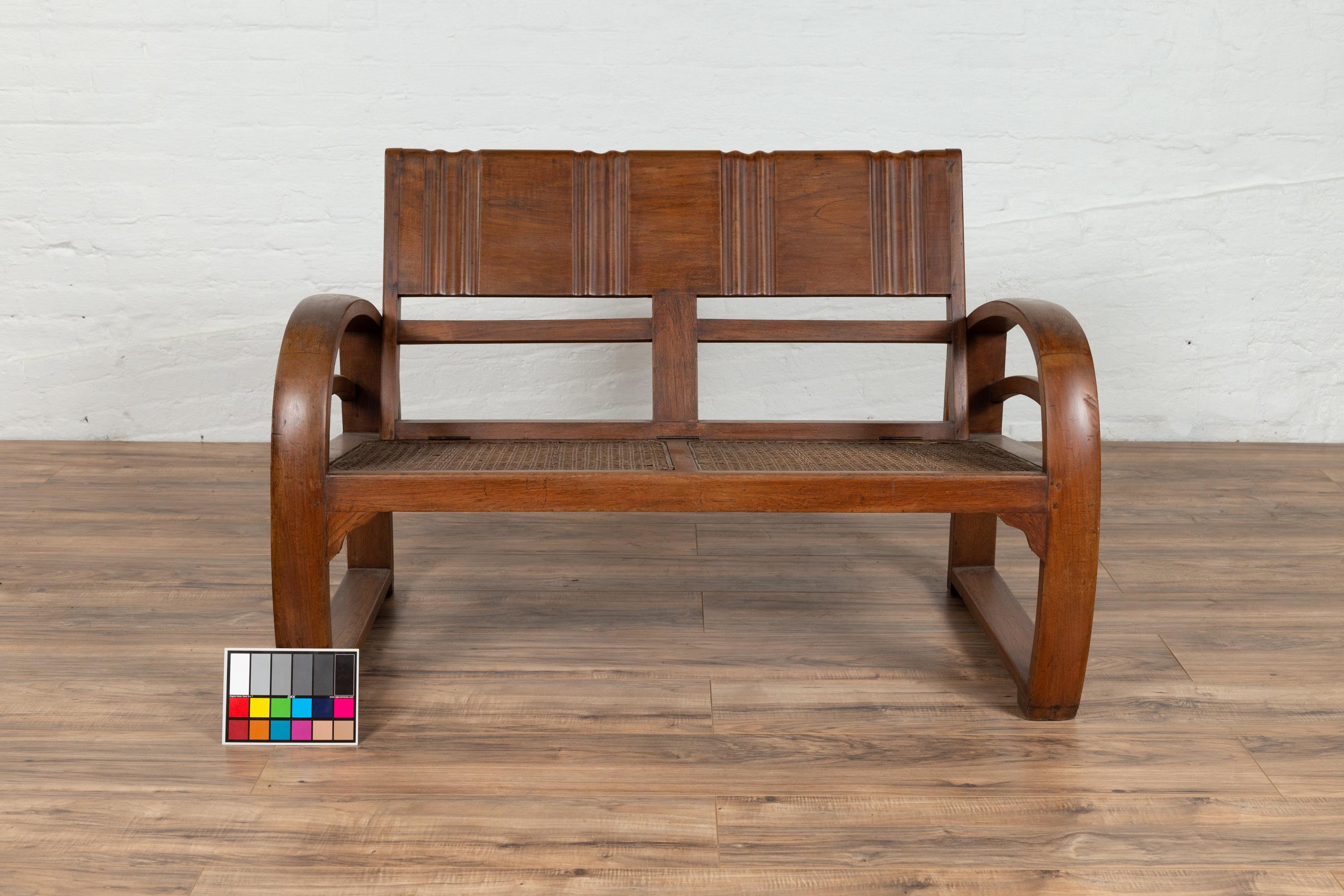 Teak Wood Settee from Madura with Folding Back, Looping Arms and Cane Seat For Sale 9