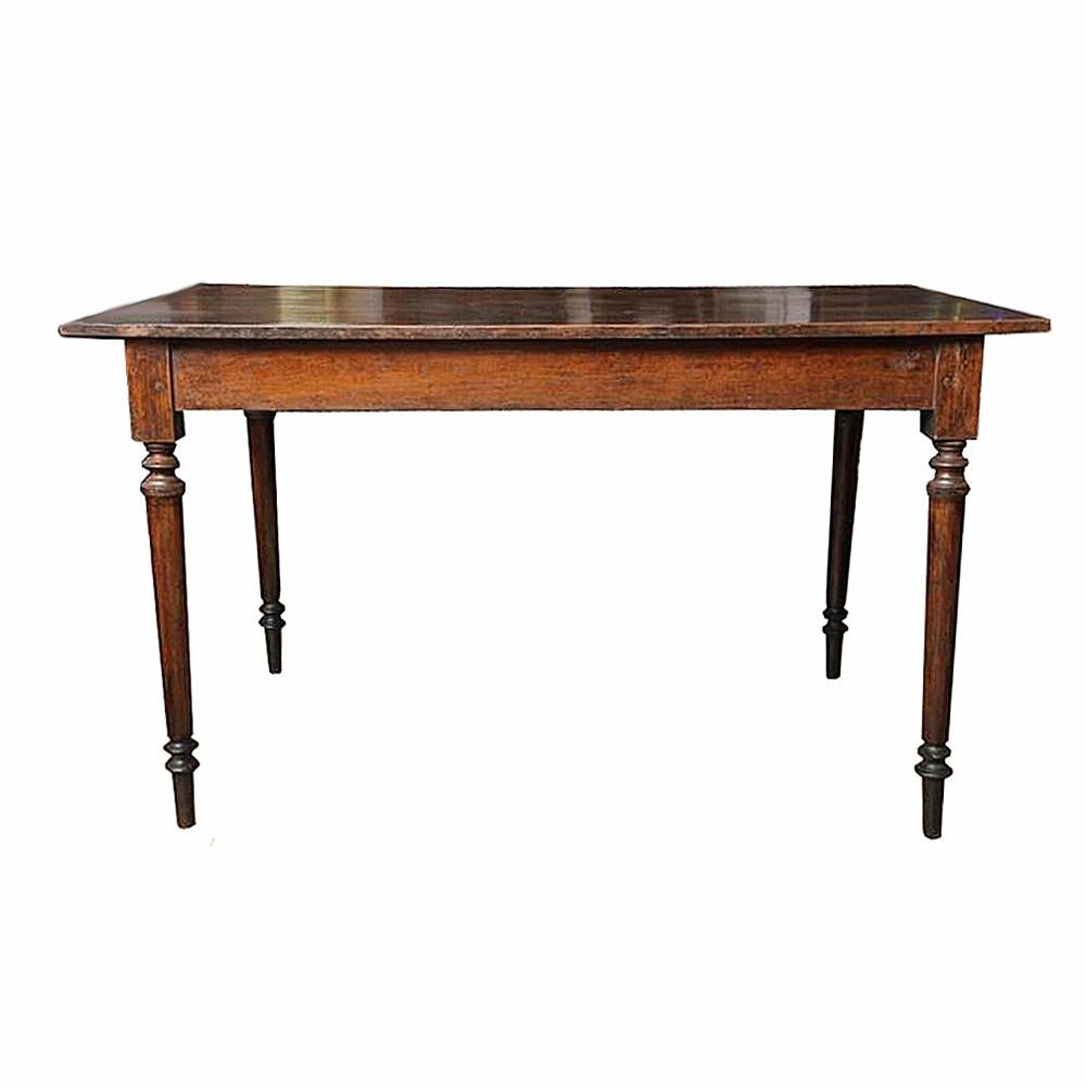 A teak wood table with turned legs, Dutch Colonial style, hand-crafted in Indonesia, circa 1950. Original dark finish. Solid structure, very good condition.