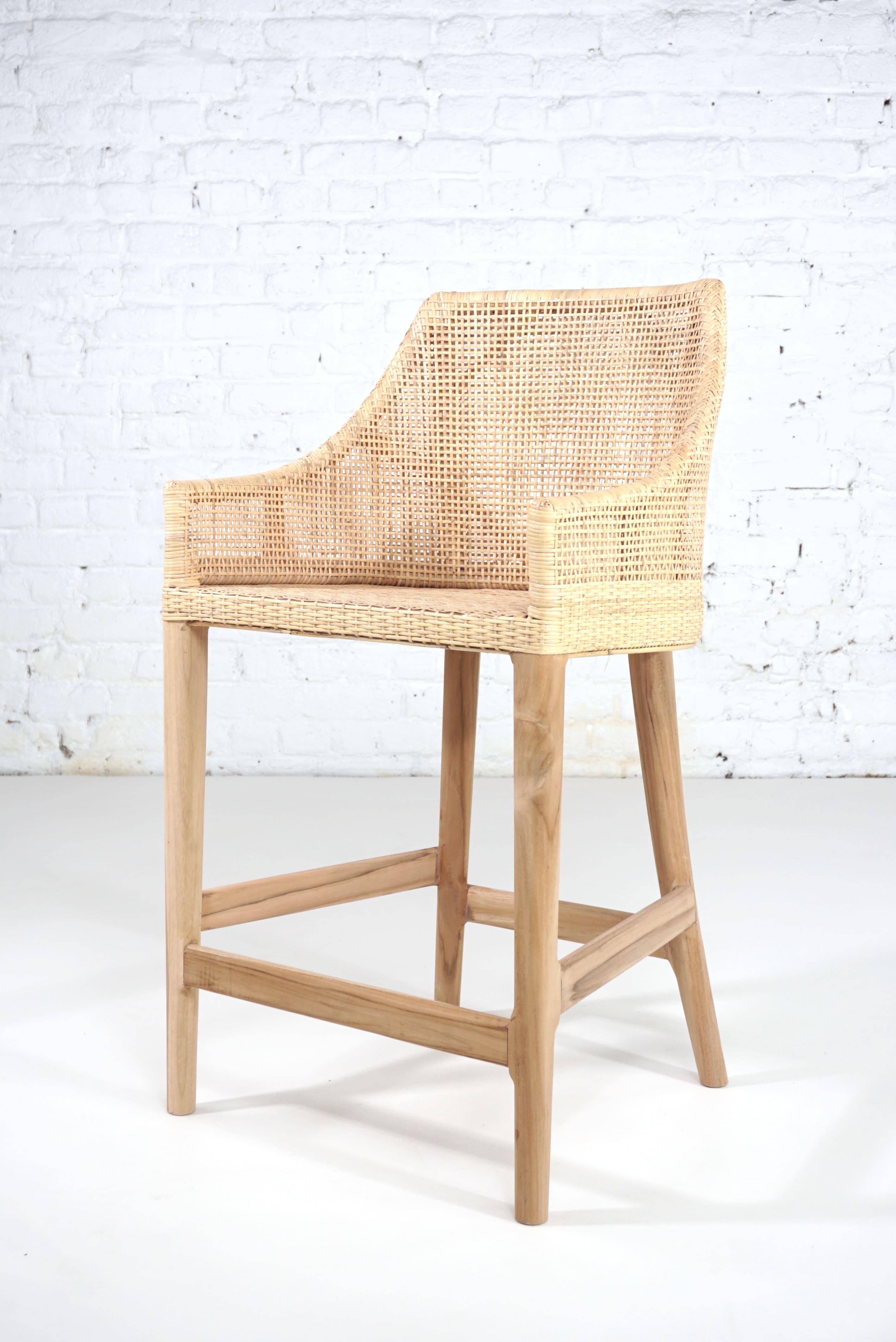 Elegant rattan counter stool with a structure in teak wooden and handcrafted braided rattan combining quality, robustness and class. Comfortable and ergonomic, aerial and poetic. The armrests height is 75cm and the seat height is 64cm. In excellent