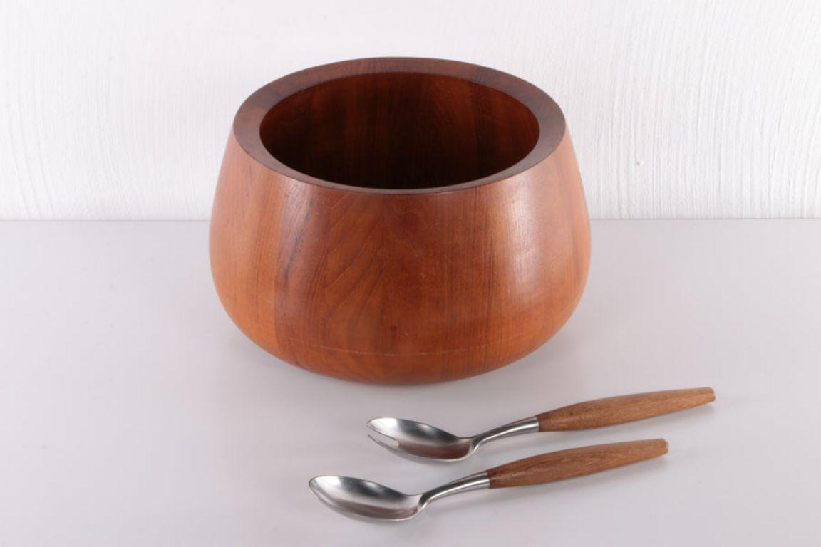 Jens Quistgaard Teak Wooden Bowl With Salad Servers by Dansk Design

Made in Denmark, a solid wooden bowl with original salad cutlery.

Danish sculptor and industrial designer Jens Quistgaard (1919-2008)
had a long and successful career in Denmark