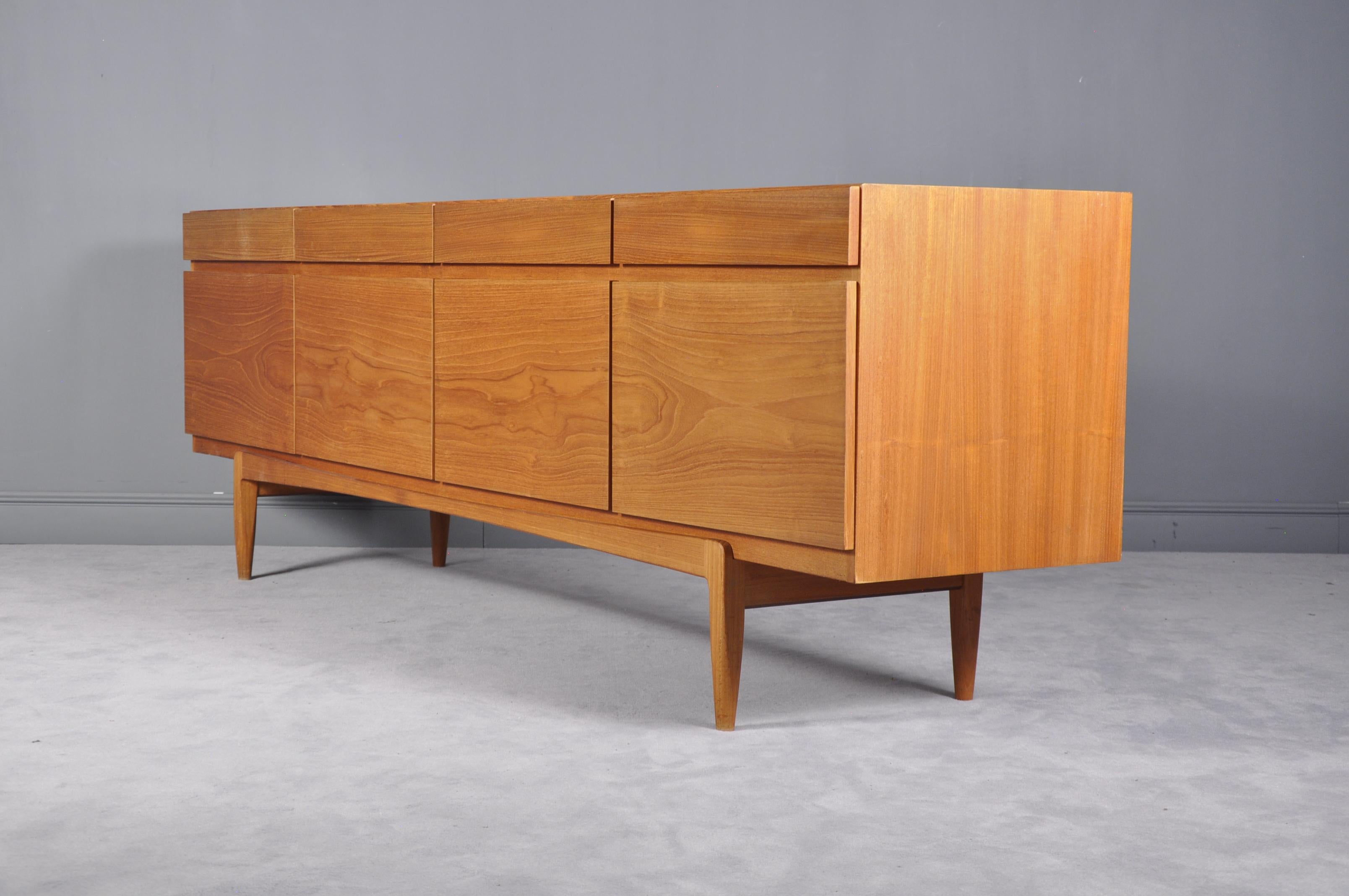 A beautiful sideboard/credenza in teak. Design by Ib Kofod-Larsen. Manufactured by Faarup Denmark. Model no.66. Behind the doors with shelves and drawers.

On this sideboard, natural wood grain is utilized to create a sense of unity in its