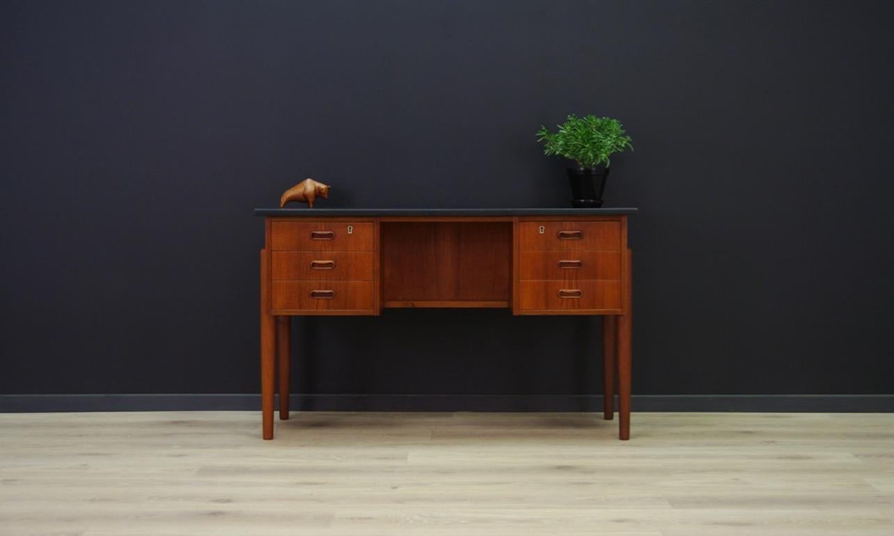 Desk from the 1960s-1970s, minimalistic Danish design, perfect in every detail. Surface veneered with teak, original handles. Black tabletop. It has six capacious drawers and a book shelf at the back. Preserved in good condition (minor scratches, no