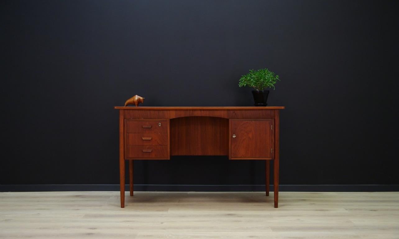 Classic desk from the 1970s, Danish design. Has a key. Finished with teak veneer. Three useful drawers, and a spacious chest. On the back bookshelves. Preserved in good condition (small dings and scratches, filled veneer loss) - directly for