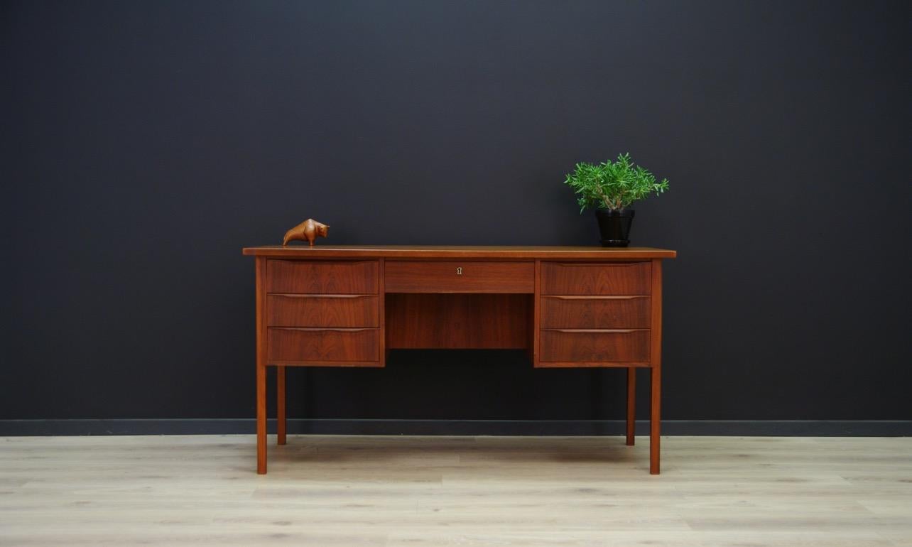 Classic Scandinavian desk from the 1960s-1970s, Minimalist Danish design. Surface veneered with teak, solid wooden legs. The desk has seven drawers. No key. Preserved in good condition (small bruises and scratches), directly for use.

Dimensions:
