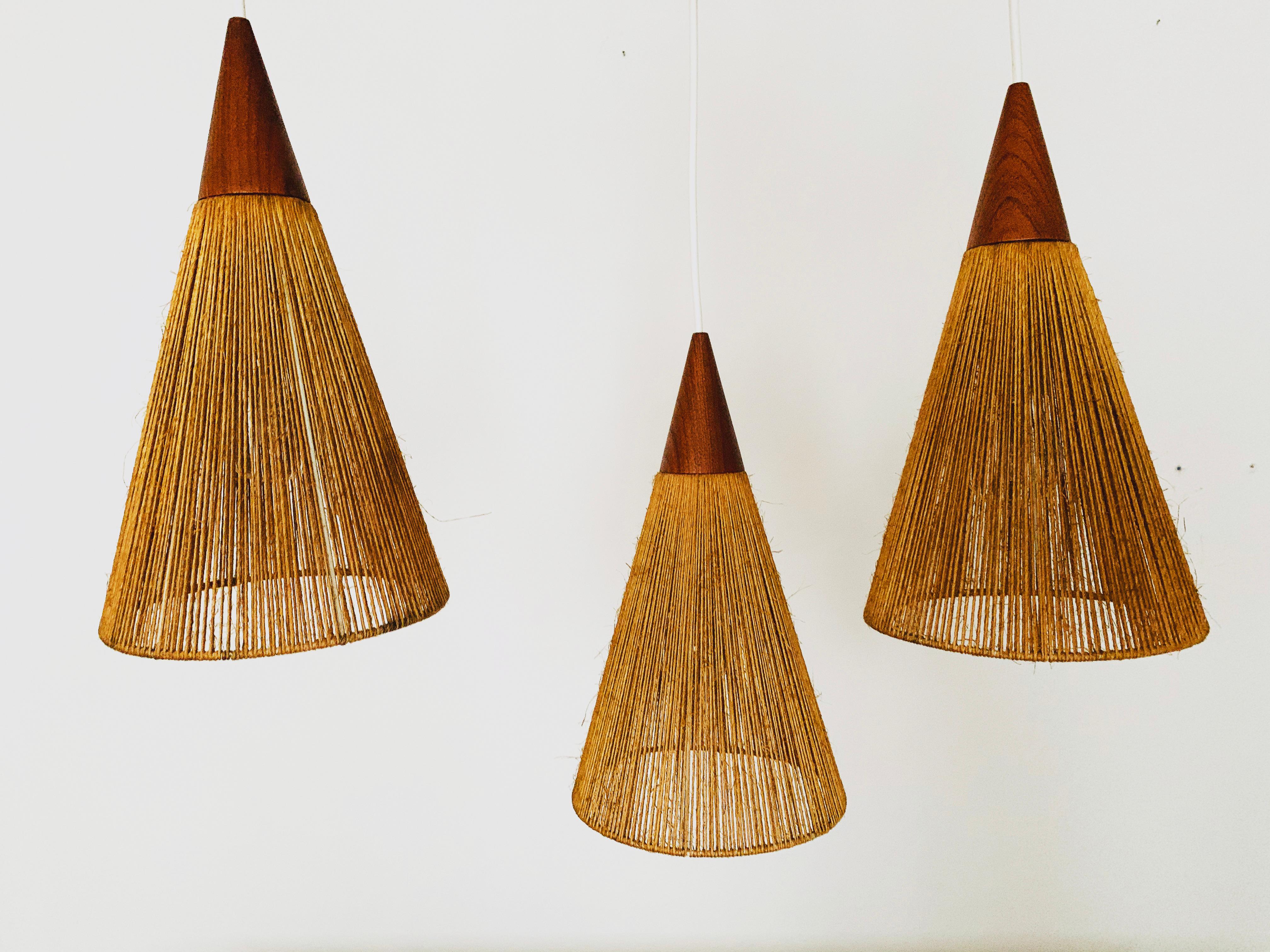 Mid-20th Century Teakwood and Raffia Bast Cascading Lamp by Jean Rispal For Sale