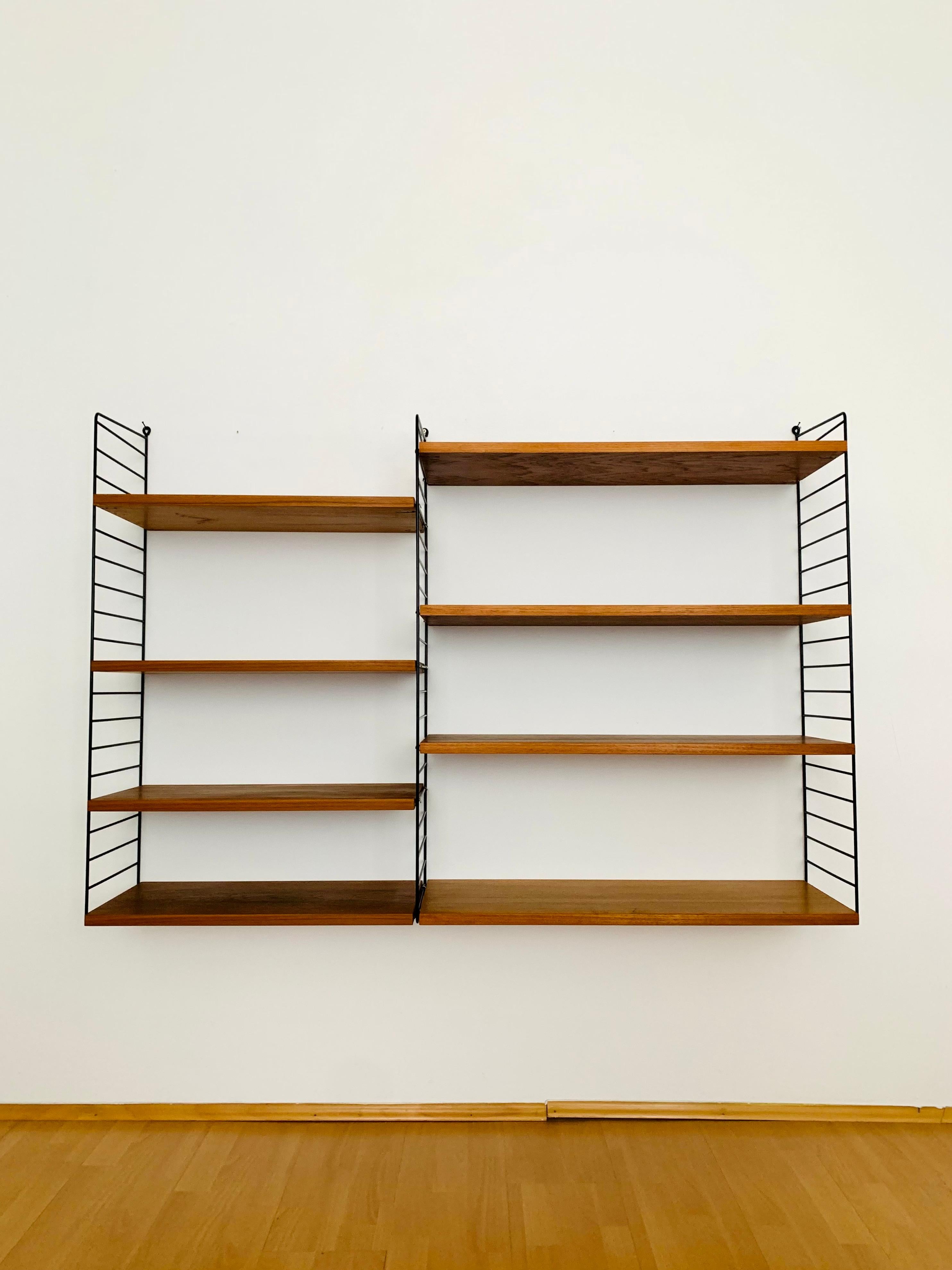 Nice teak shelf from the 1950s.
Wonderful high -quality workmanship and an absolute favorite.
Flexible configurable.

Design: Kajsa & Nils Nisse Strinning
Manufacturer: String Design

Condition:

Very good vintage condition with slight signs of