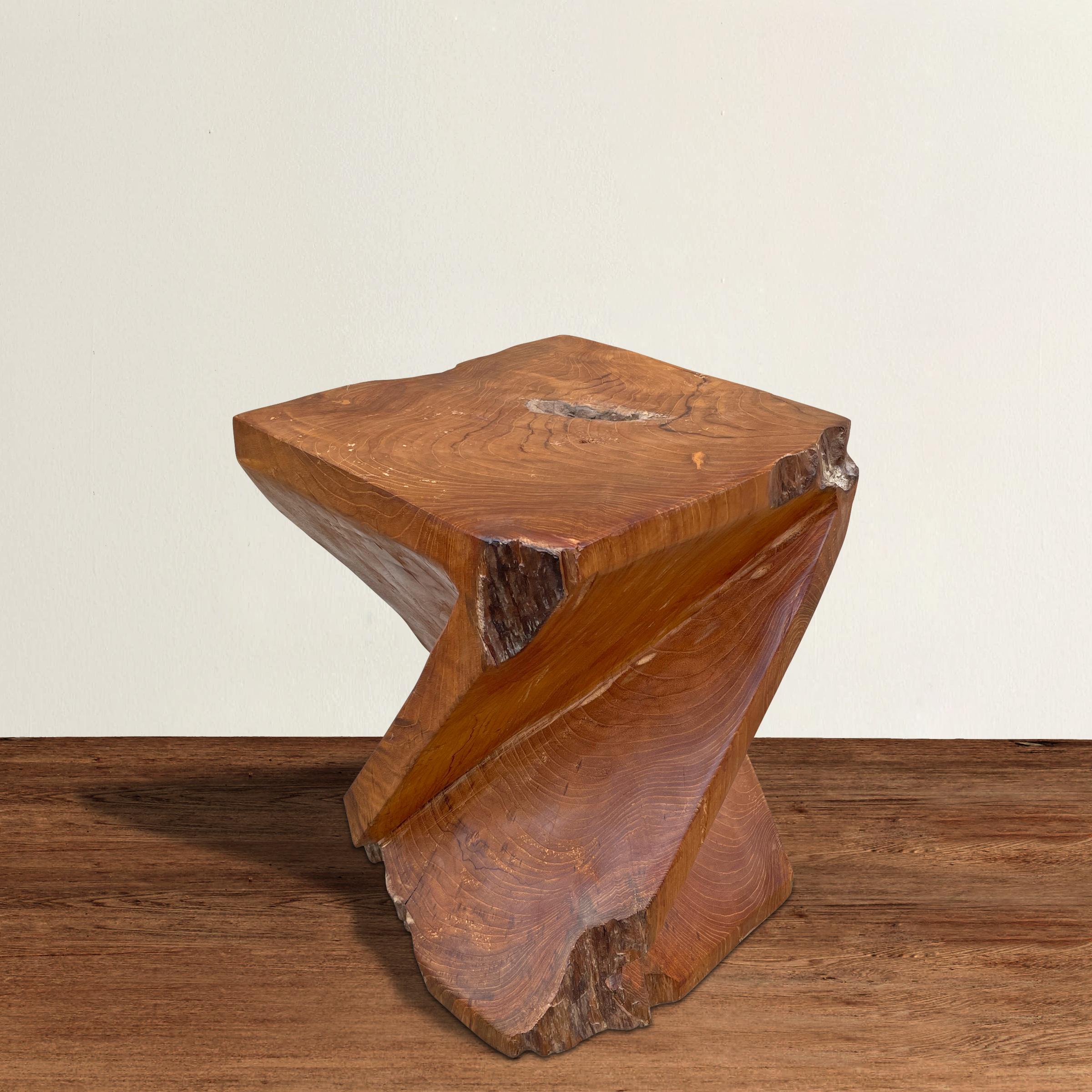 A bold side table with a 'Z' form, and carved from one piece of teakwood with natural live edges.