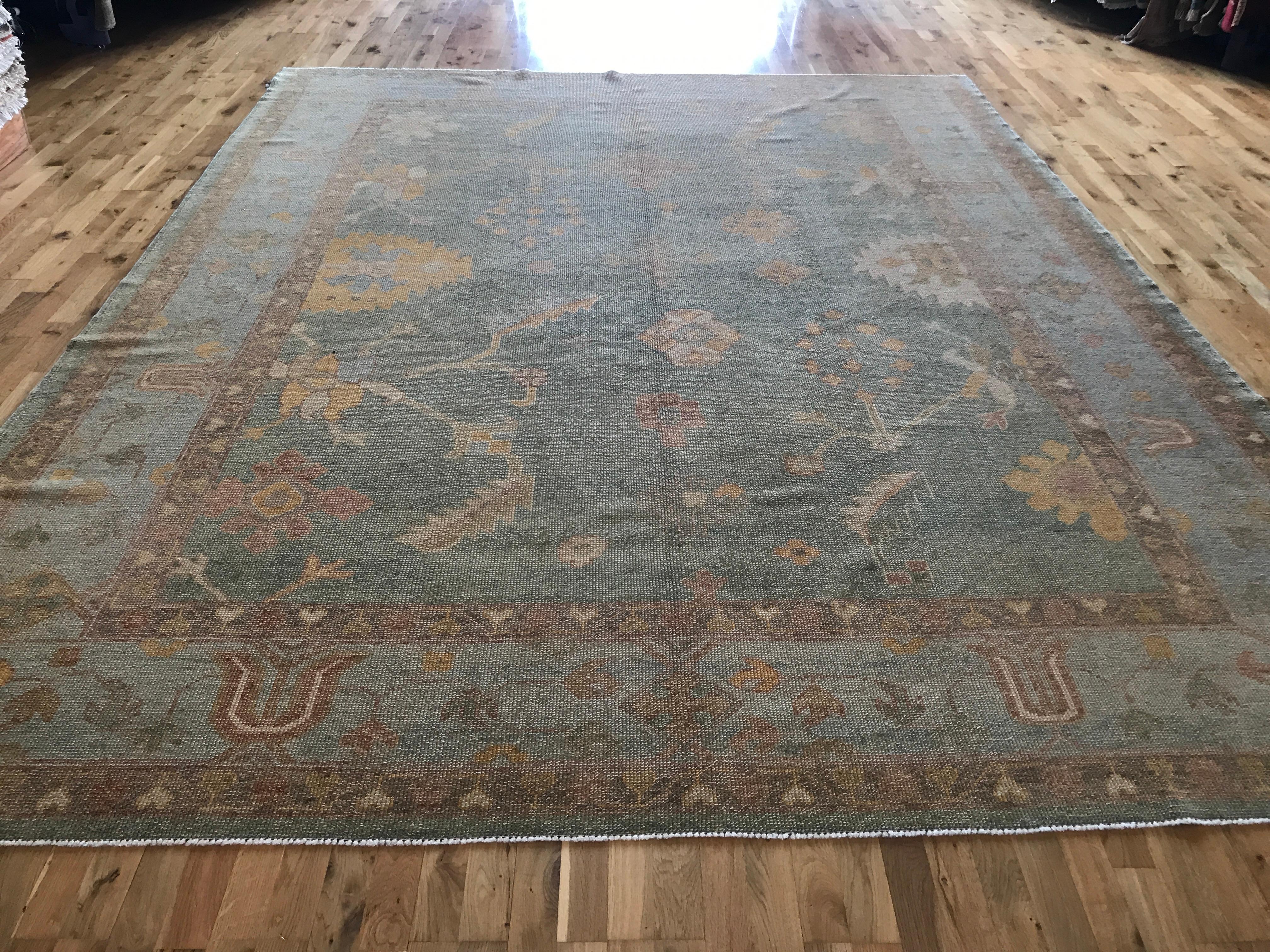 A contemporary take on a centuries-old style known for its tame, calming quality. With its large center panel floral design this piece carries on the storied Oushak tradition. All wool. Hand knotted in Turkey using vegetal dyes.