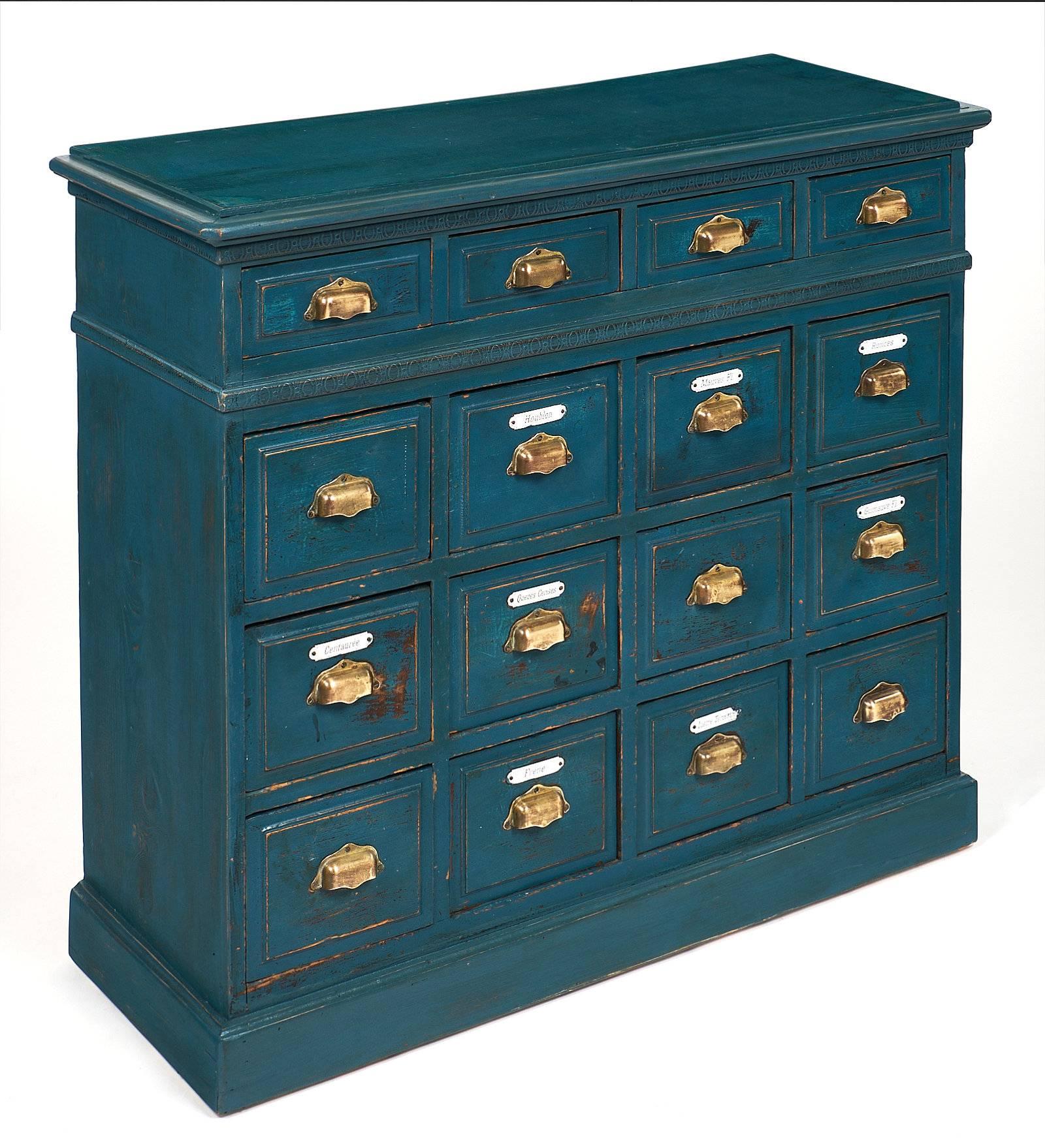 All original antique apothecary cabinet with 16 dovetailed drawers, made of fir. This piece has porcelain tags and solid brass handles. We love the great original teal blue color.