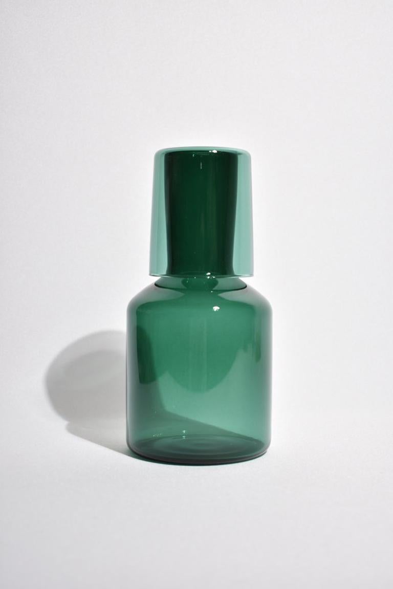 Teal carafe set by Maison Balzac inspired by the traditional sets used in France and displayed on a bedside table at night. 

Food grade colored glass, individually mouth blown. 
Heat and cold resistant.
Hand wash recommended.

Dimensions: