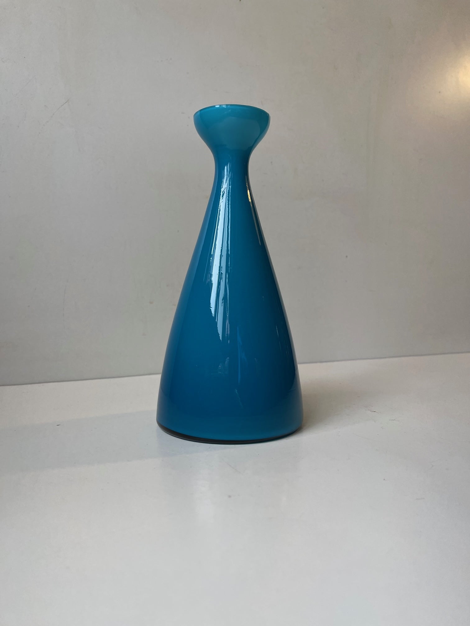 A rare teal blue cased opaline glass vase by Holmegaard, circa 1970. Probably a variation of the Carnaby series by Per Lütken. Measurements: H: 20 cm, Diameter: 10/5 cm.