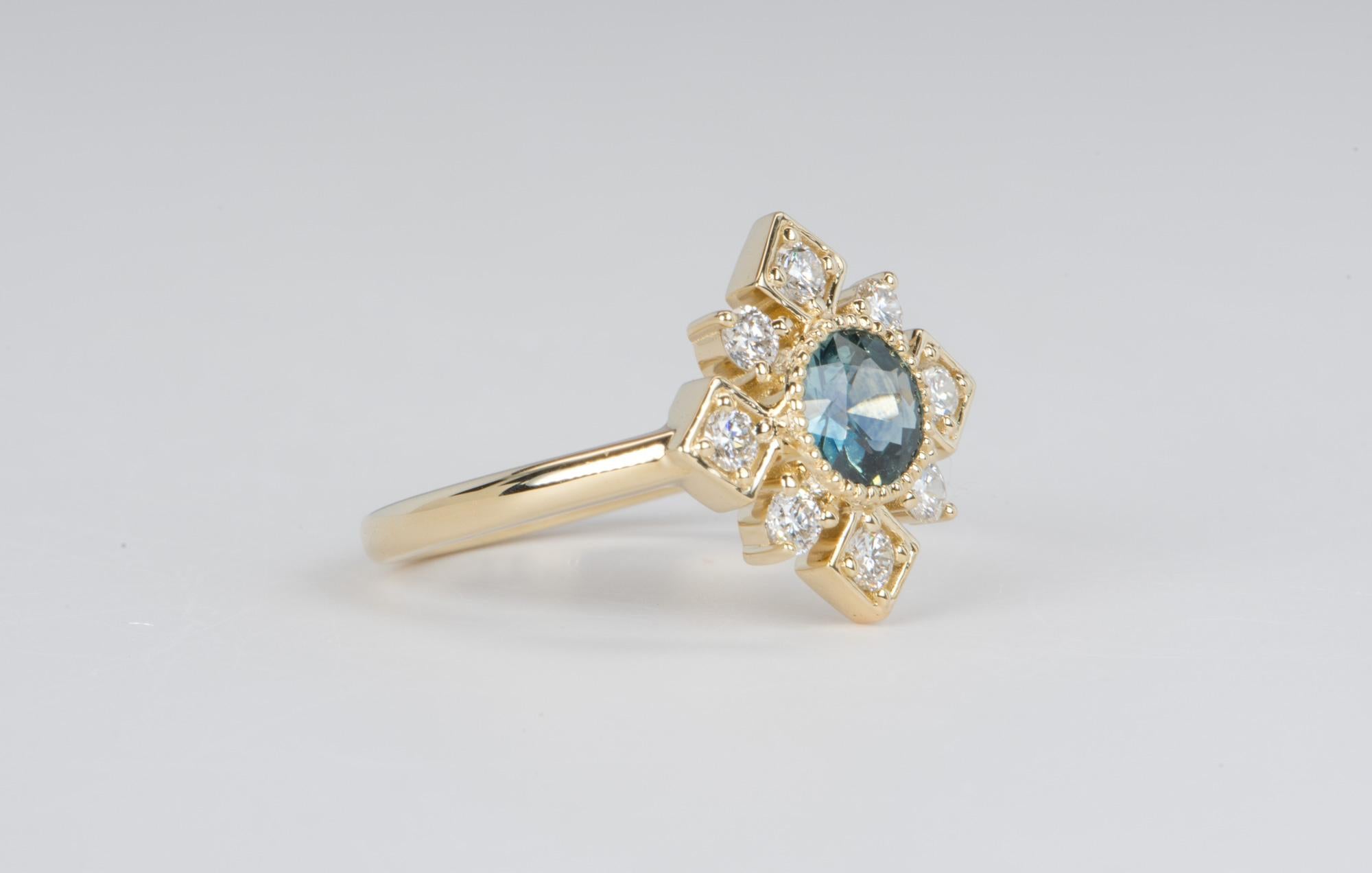 ♥  A solid 14k yellow gold engagement ring featuring a beautiful Montana sapphire in the center, flanked by a brilliant diamond halo with the diamonds set in alternating round and square design
♥  The overall setting measures 14.3mm in width, 14.2mm