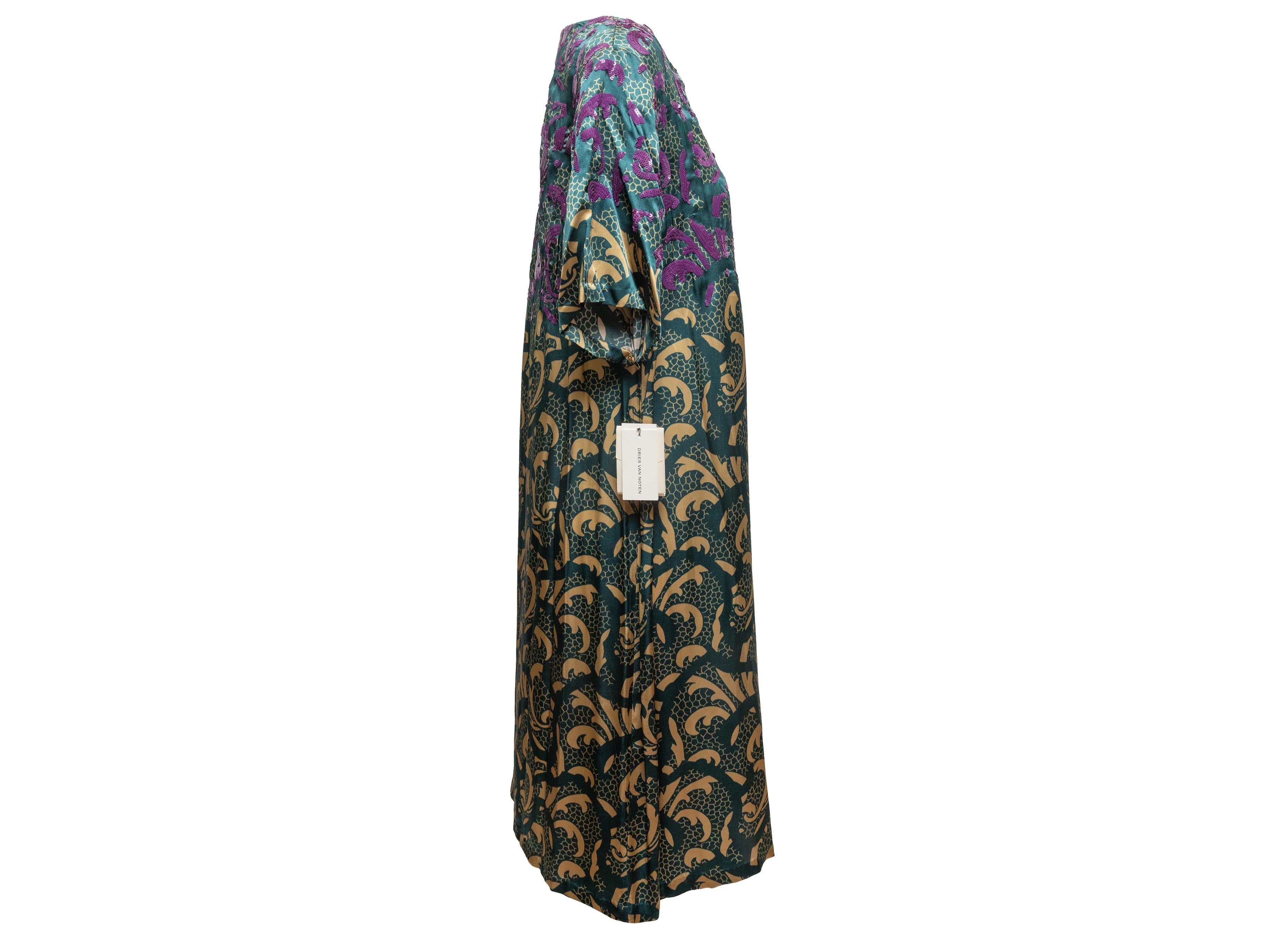 Teal, cream, and purple printed short sleeve dress by Dries Van Noten. Crew neck. Sequin embellishments at bust and shoulders. 42