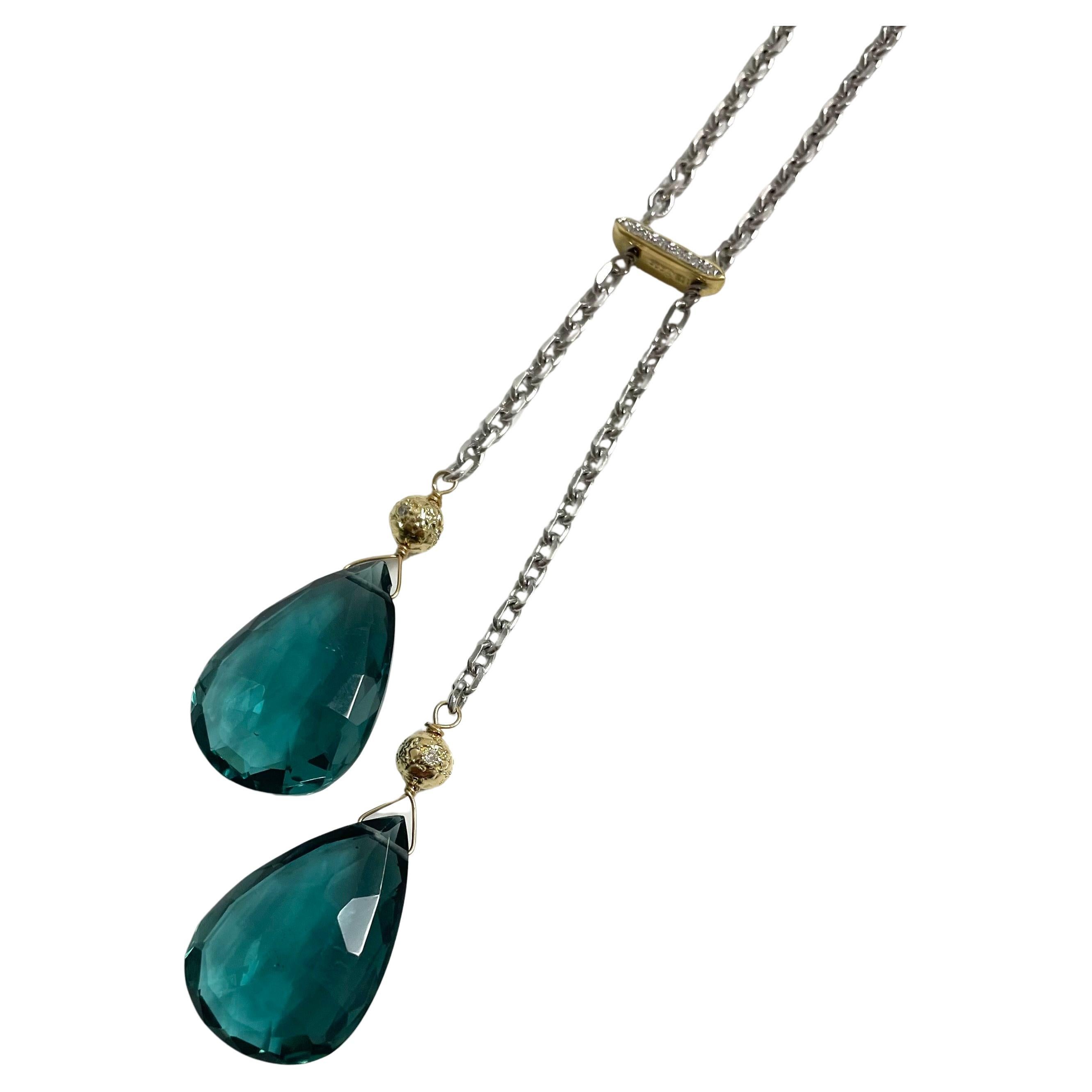 Description
Vibrant Teal Quartz double drops accented with diamonds and 14k yellow gold on a diamond cut 14k white gold chain.
Item # N3706

Materials and Weight
Teal quartz 34cts, 25 x 16 mm, pear shape
Pave diamonds
14k yellow gold pave diamond