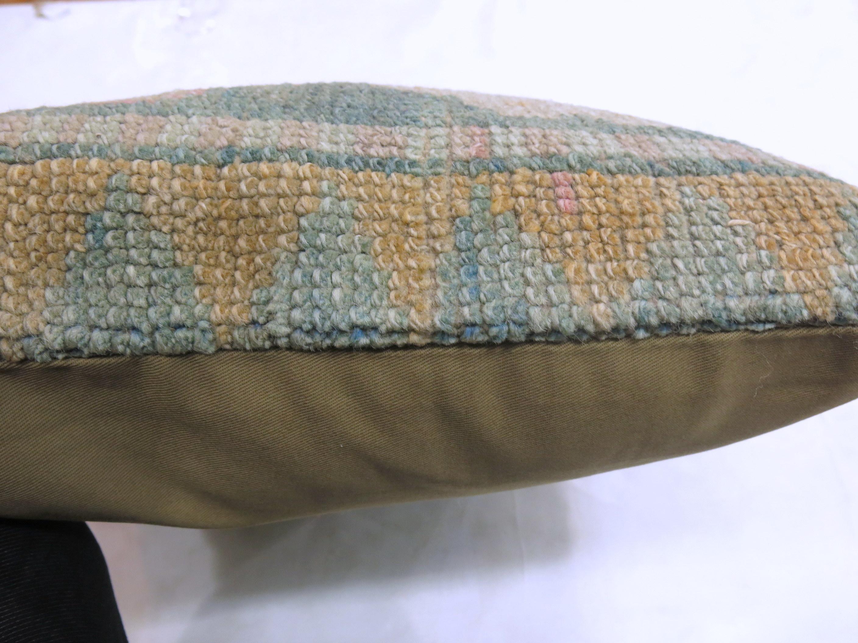Square pillow made from a border of vintage Turkish rug. Measures: 20” x 20”. Pops of predominantly teal, pink, beige.