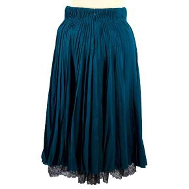 Dior Teal Pleated Silk Midi Skirt with Black Lace & Mesh
 

 - Teal blue pleated silk midi skirt with black lace and mesh trims 
 - Slit down one side revealing the black mesh underskirt 
 - Black lace trim at the bottom hem
 - Boning inside at the