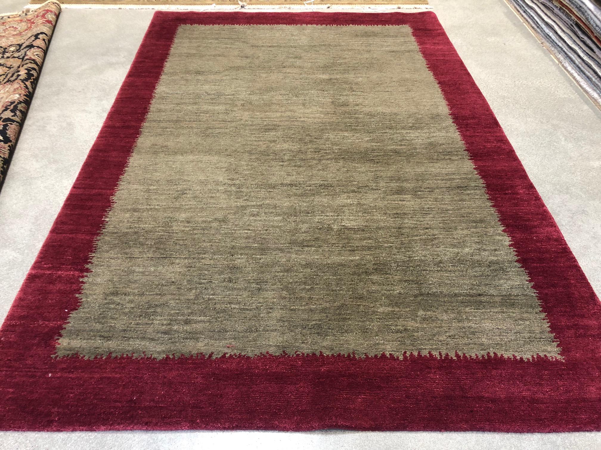 Teal rug with maroon border
colors: teal, maroon.