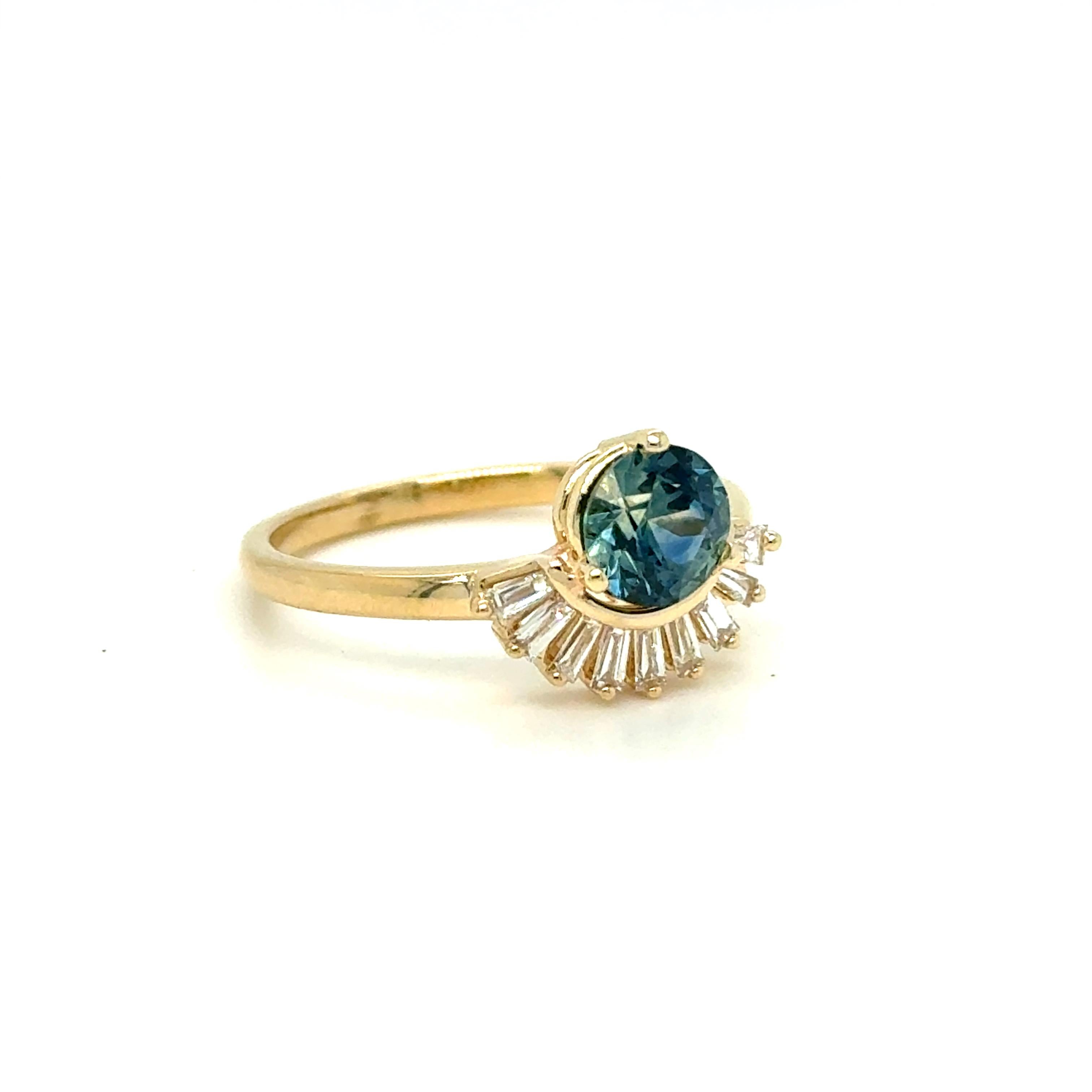 What a ray of sunshine this ring is! Beautiful, unique design, sparkly diamonds, and a stunning natural Teal Sapphire center. There are 9 Baguette Cut Diamonds, Natural, totaling 0.36ct, of G/VS2 quality. In the center, the ring features a Natural,