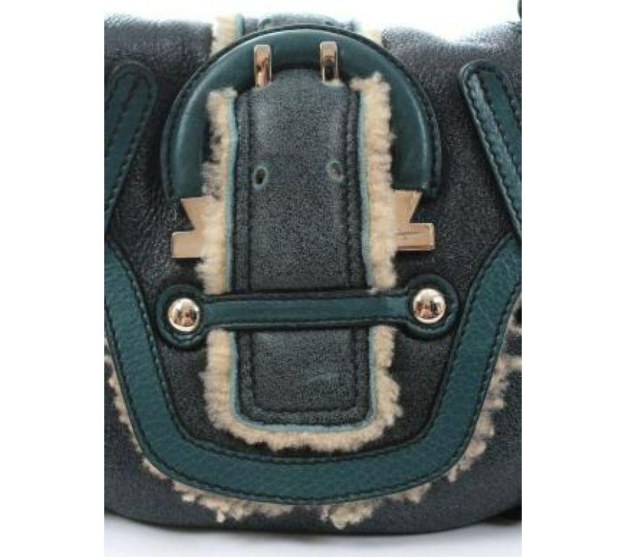 Measures: 28cm W x 20cm H x 8cm D. /Strap drop: 27cm. One Size. Salvatore Ferragamo shearling shoulder bag - made from a distressed teal blue soft shearling with leather trim and silver-tone hardware. Signature Gancio buckle detail. Flap fastening