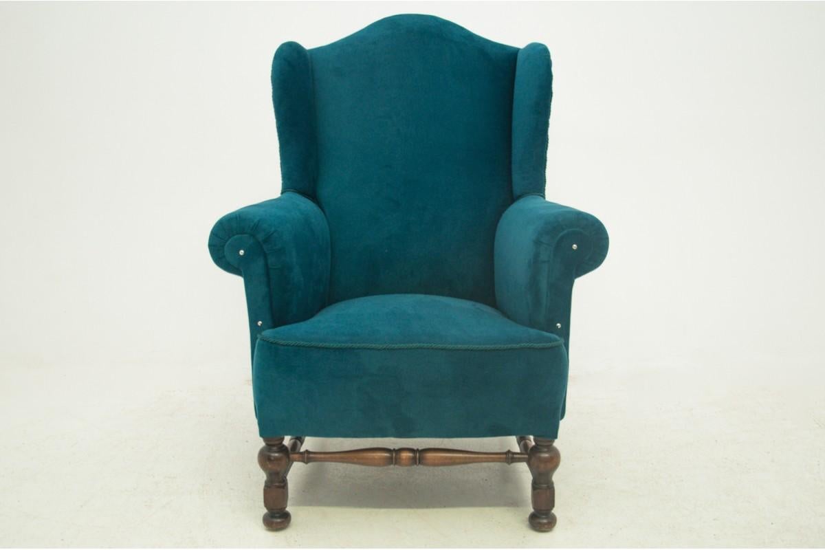 A wing, fireside armchair comes from Northern Europe. Year of origin around 1910. Very good condition. The armchair has been professionally renovated and upholstered in a new turquoise velvet fabric.

Wood: Walnut.

Dimensions: height: 105 cm;