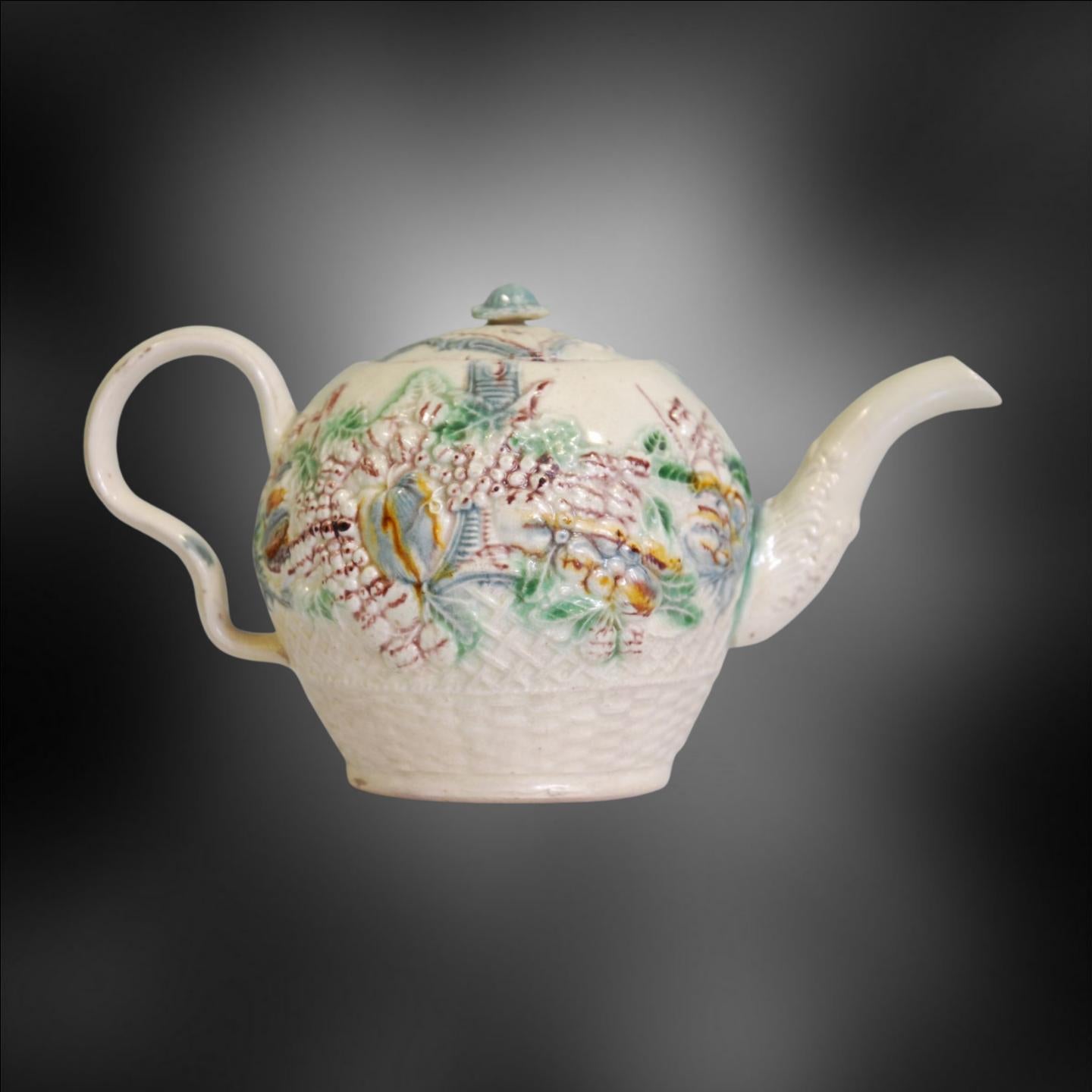 A classic Greatbatch teapot, with ear-shaped handle, in the form of a fruit basket. The fruit basket was emblematic of hospitality, being full of rare, exotic items.

William Greatbatch was an English potter who lived from 1735 to 1813. He was