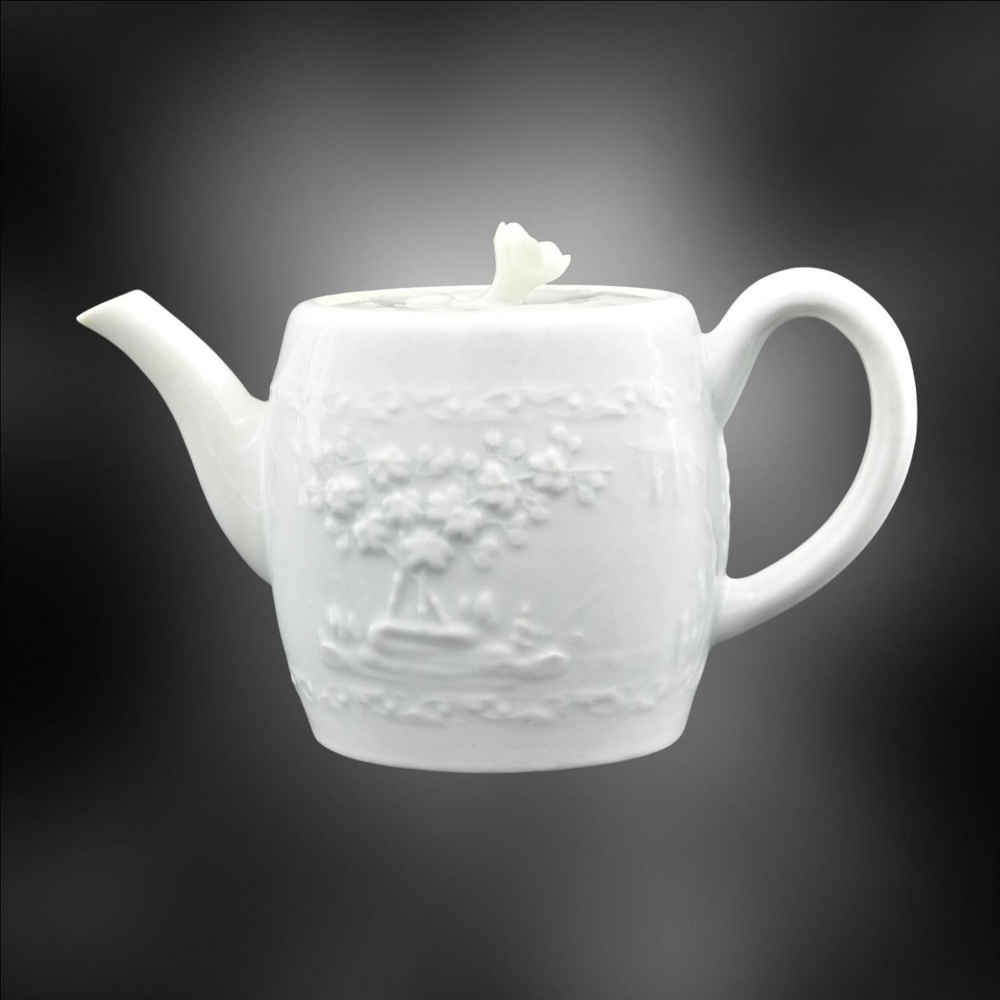 A blanc de chine teapot, with moulded decoration of a fishing scene – considerably rarer than the more common flowers.

Barrel shaped “blanc de chine' teapot with ridged loop handle, and cover with floral knop. Teapot has press-moulded fishing