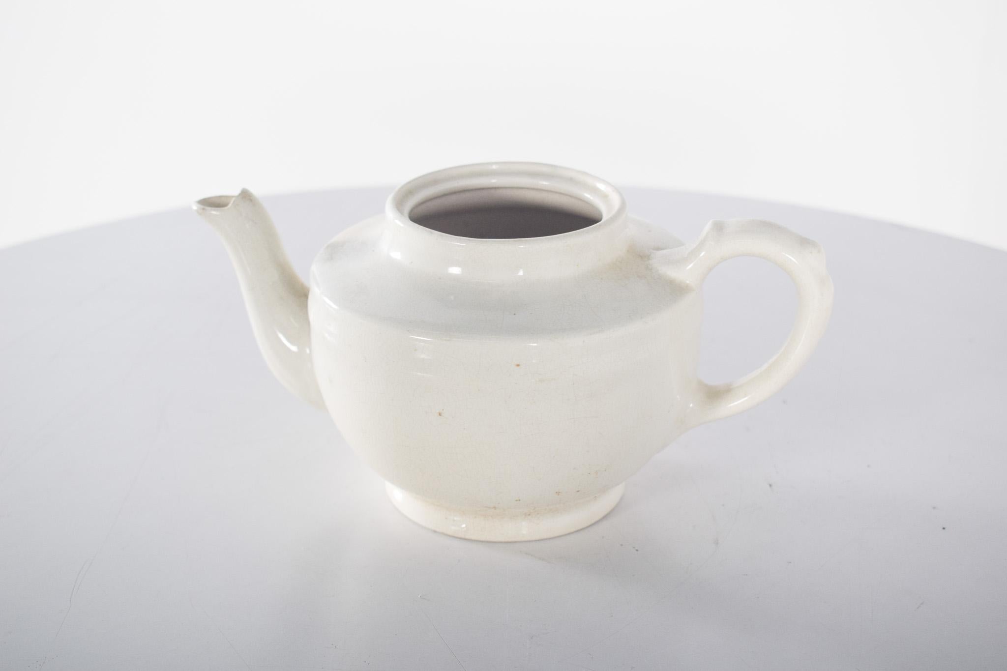English porcelain teapot. Polychrome decoration inspired by William Shakespeare's ‘Hamlet’. It has a unique design with a rectangular shape and a curved spout delicately decorated with gilded details. The handle is also decorated in gold.
The main