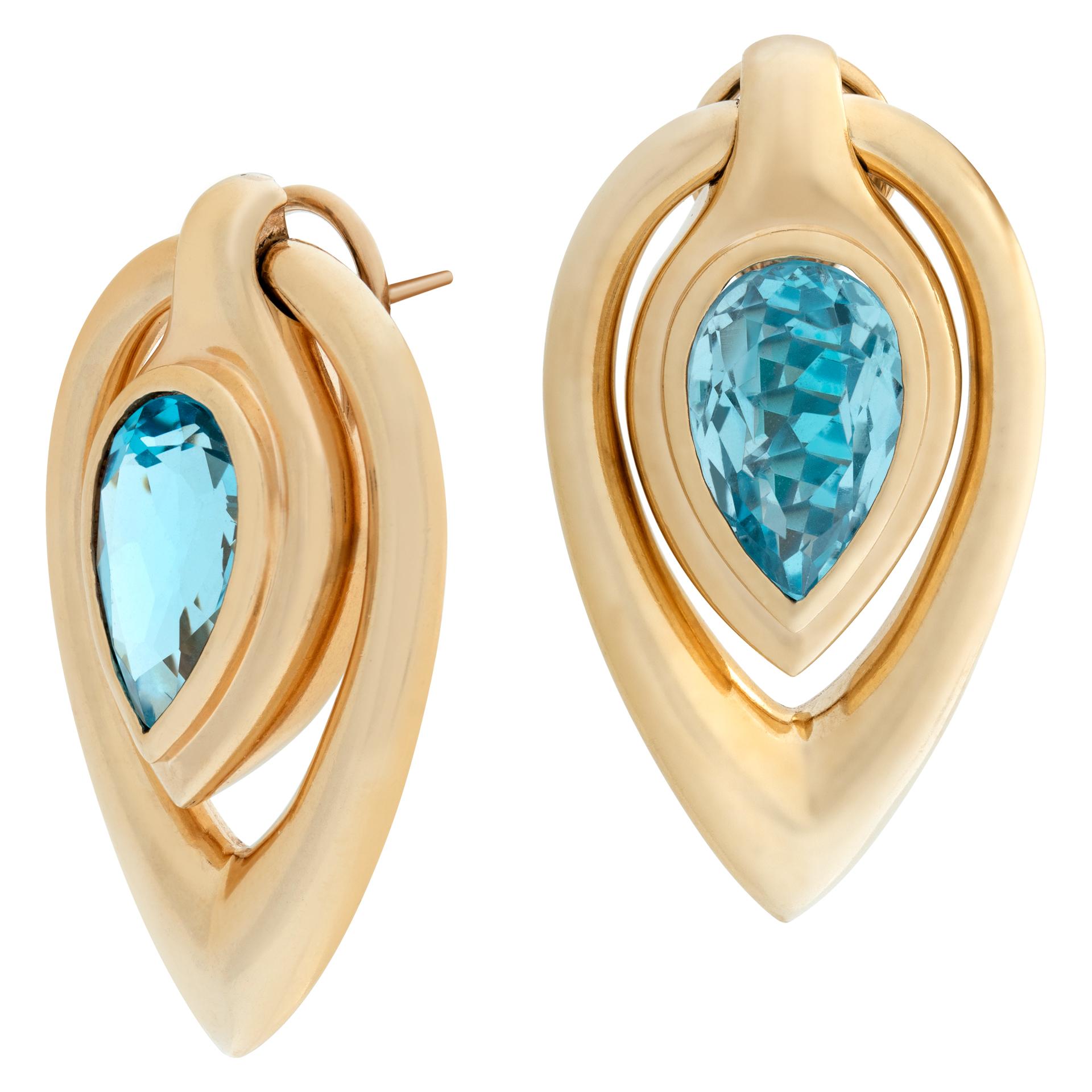 Tear drop blue topaz earrings moving with omega clips and posts in 14k yellow gold. Hanging legnth 38mm, width 20mm.