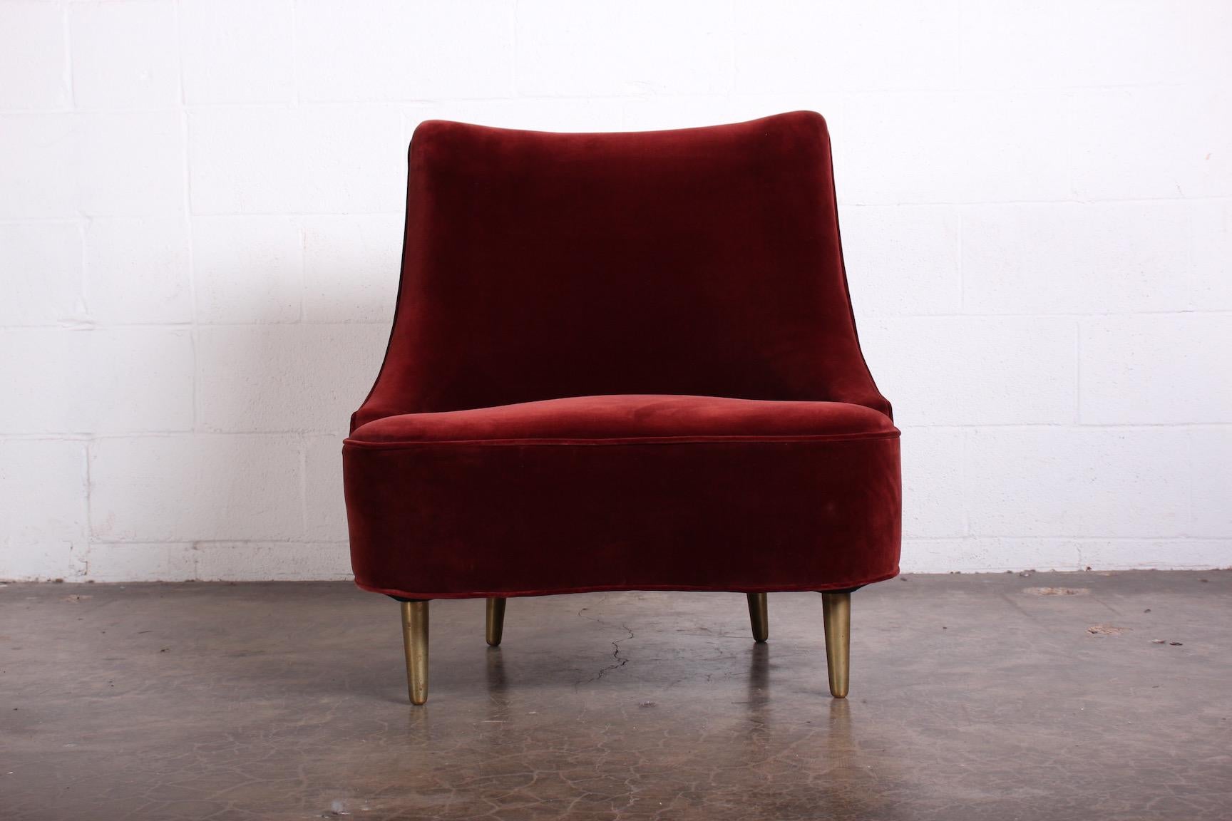A tear drop slipper chair on brass legs. Designed by Edward Wormley for Dunbar. Upholstered in Rubelli velvet.