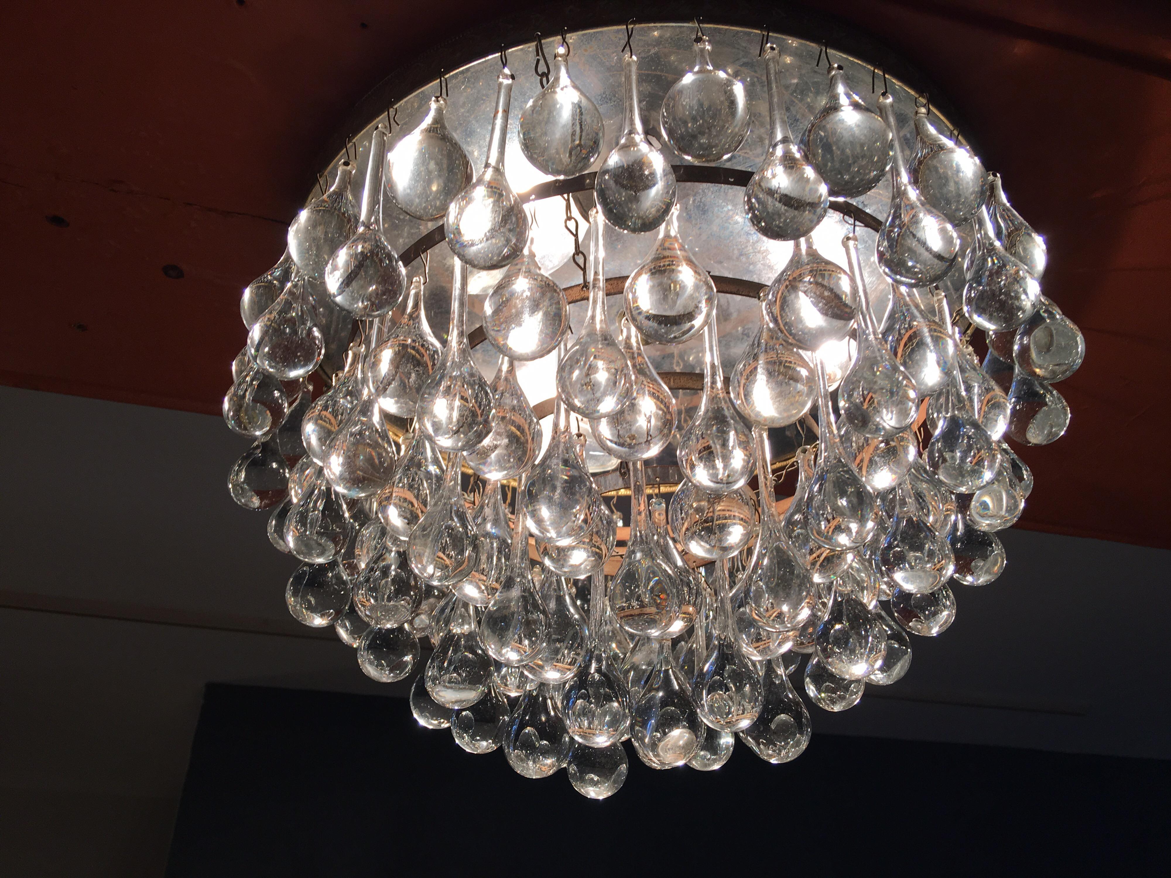 Beautiful, round chandelier with 2 types of glass crystals. Crystals alternate around rim, large and small. 3 sockets with 8 tiers of crystals. Beautiful presence!