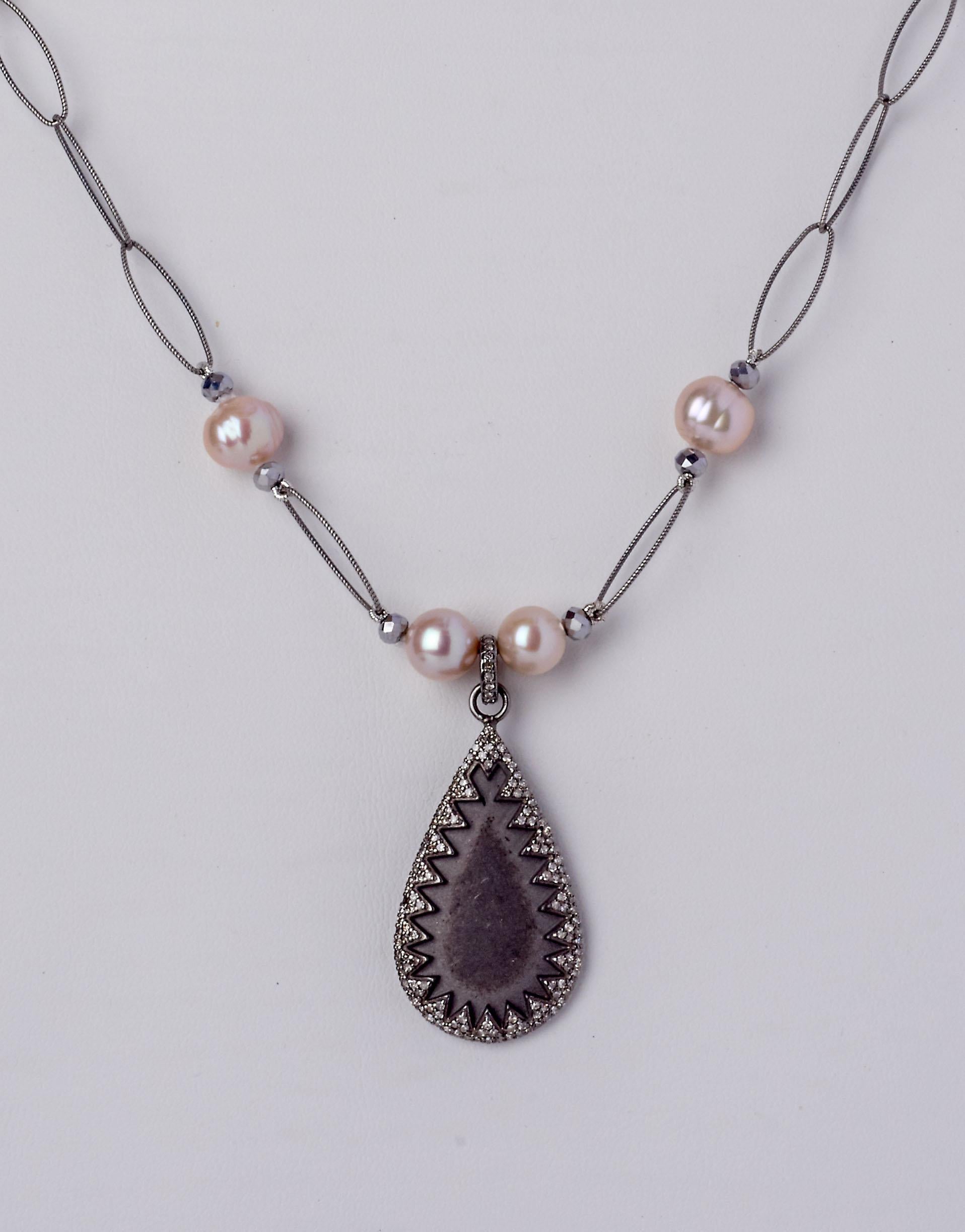 A fresh, light feminine look radiates from this expertly crafted 26 inch necklace featuring soft blush color Akoya Pearls flanked by faucet-cut Hematite beads complimented by the soft gray tones of an oxidized sterling silver oval link chain all