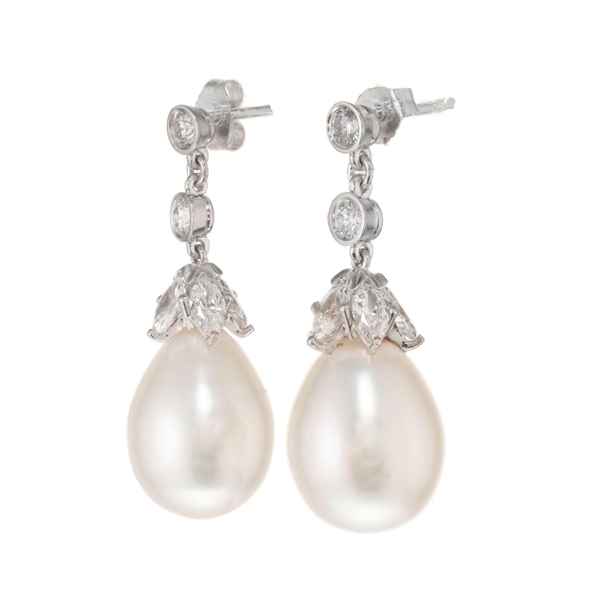 Diamond and Pearl dangle earrings. 2 tear drop South Sea Cultured pearl dangles with 4 round brilliant cut bezel set and 10 marquise cut diamonds set in platinum.

4 round brilliant cut Diamonds, approx. total weight .56cts, I, VS – SI, 3,3mm
10