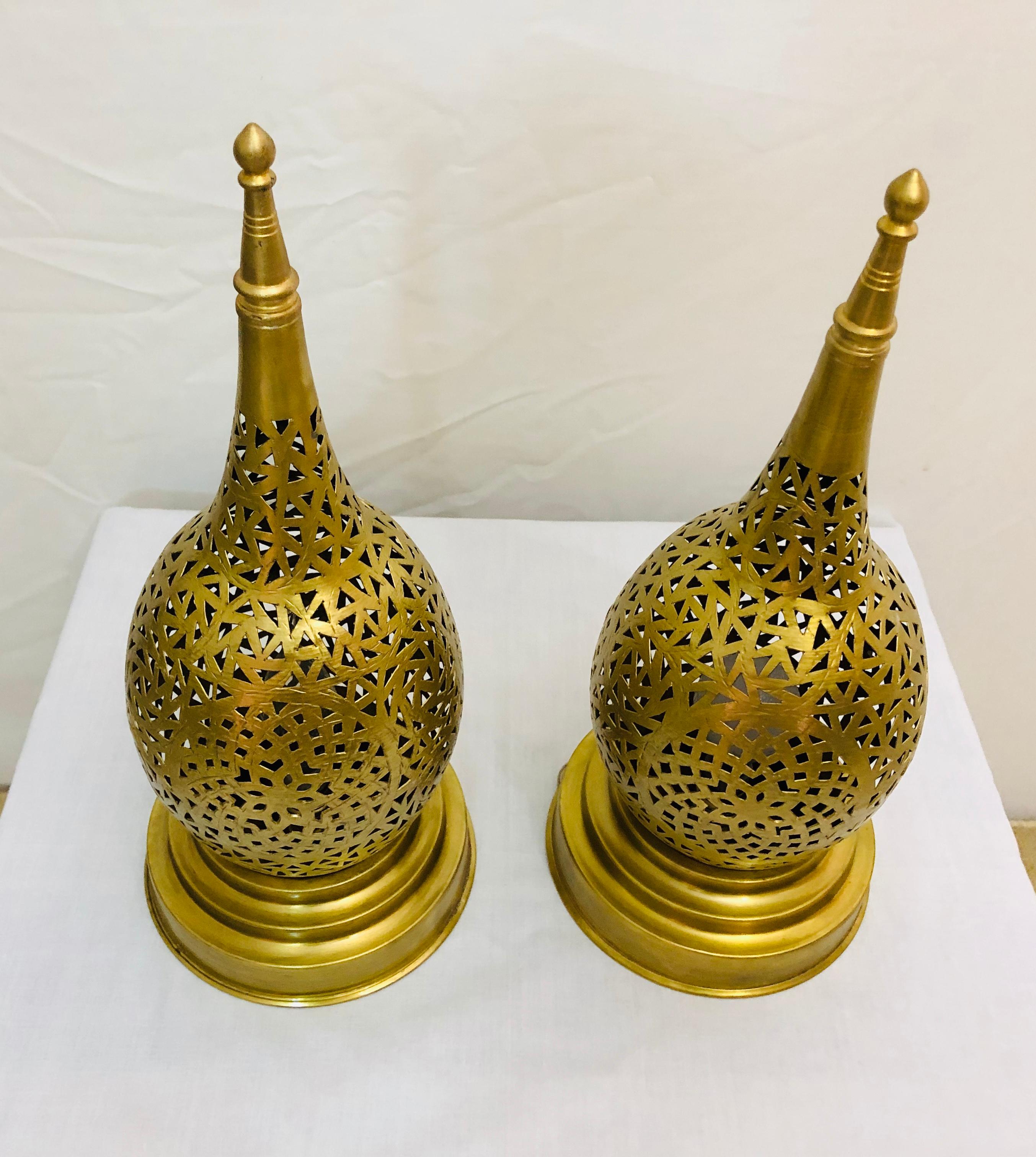 The intricate filigree design work of this handcrafted brass tear-shaped lamp will elevate the ambiance of any room. Featuring a wonderfully unique design aesthetic, these pair of table lamps emit a soft, filtered light.

Dimensions: 6.25